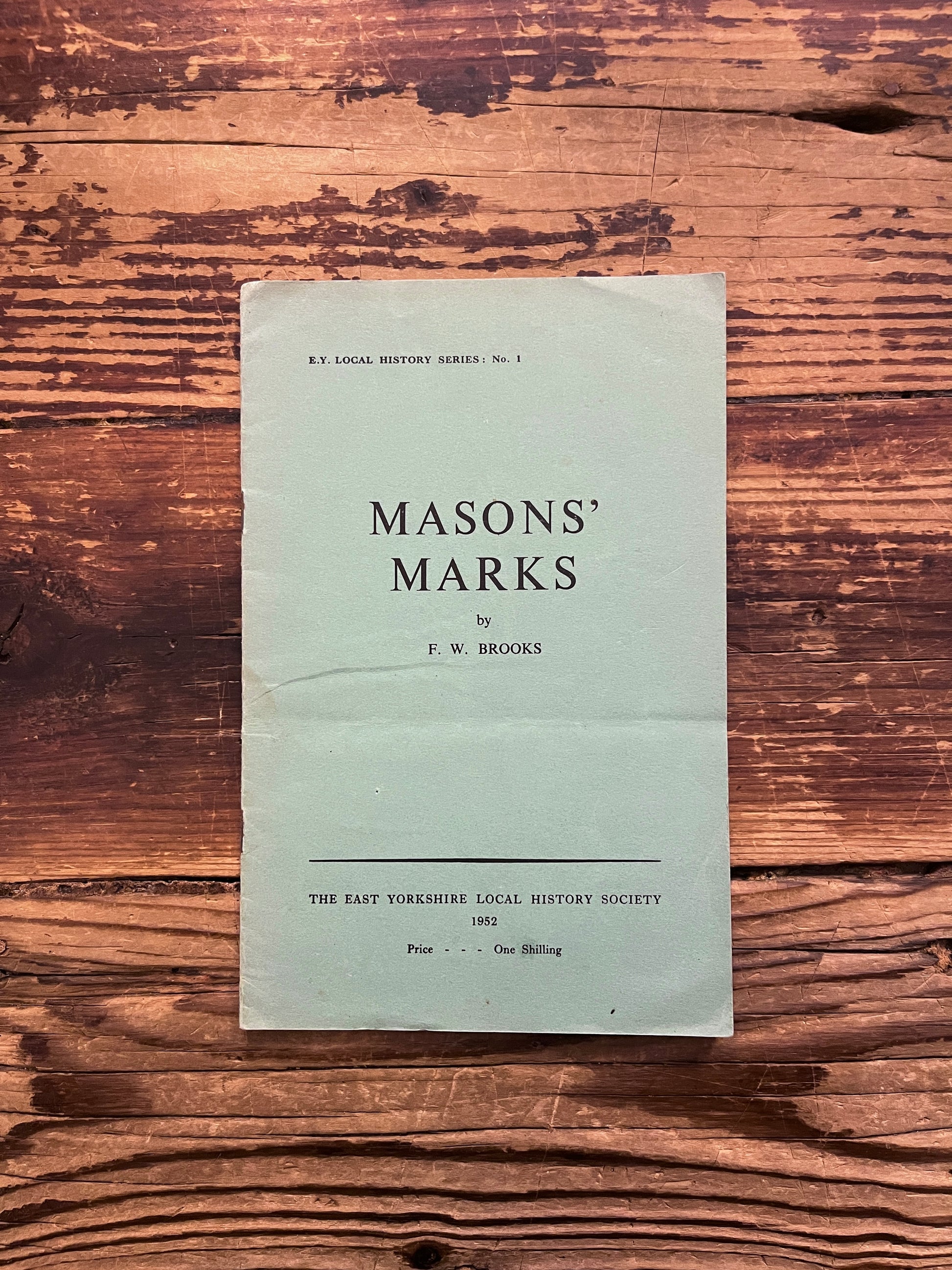 Front cover of book titled 'Masons' Marks' by F.W. Brooks on a wooden surface