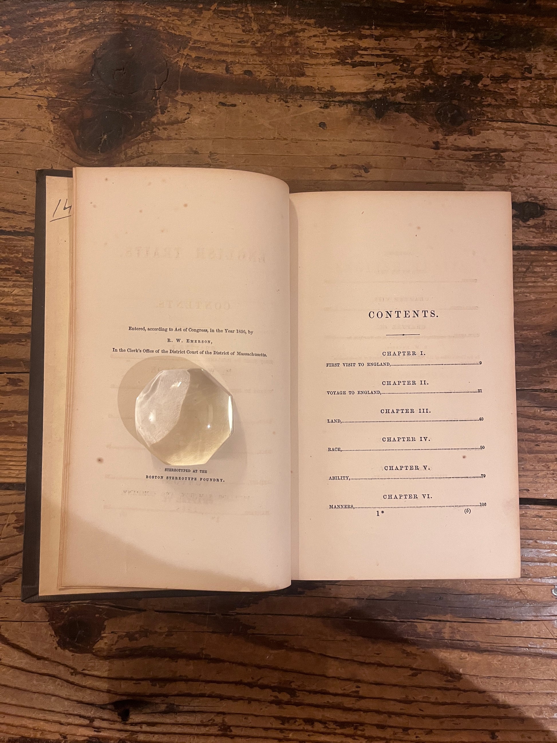 phtoto of the edition page of the book "english traits"on a wooden background