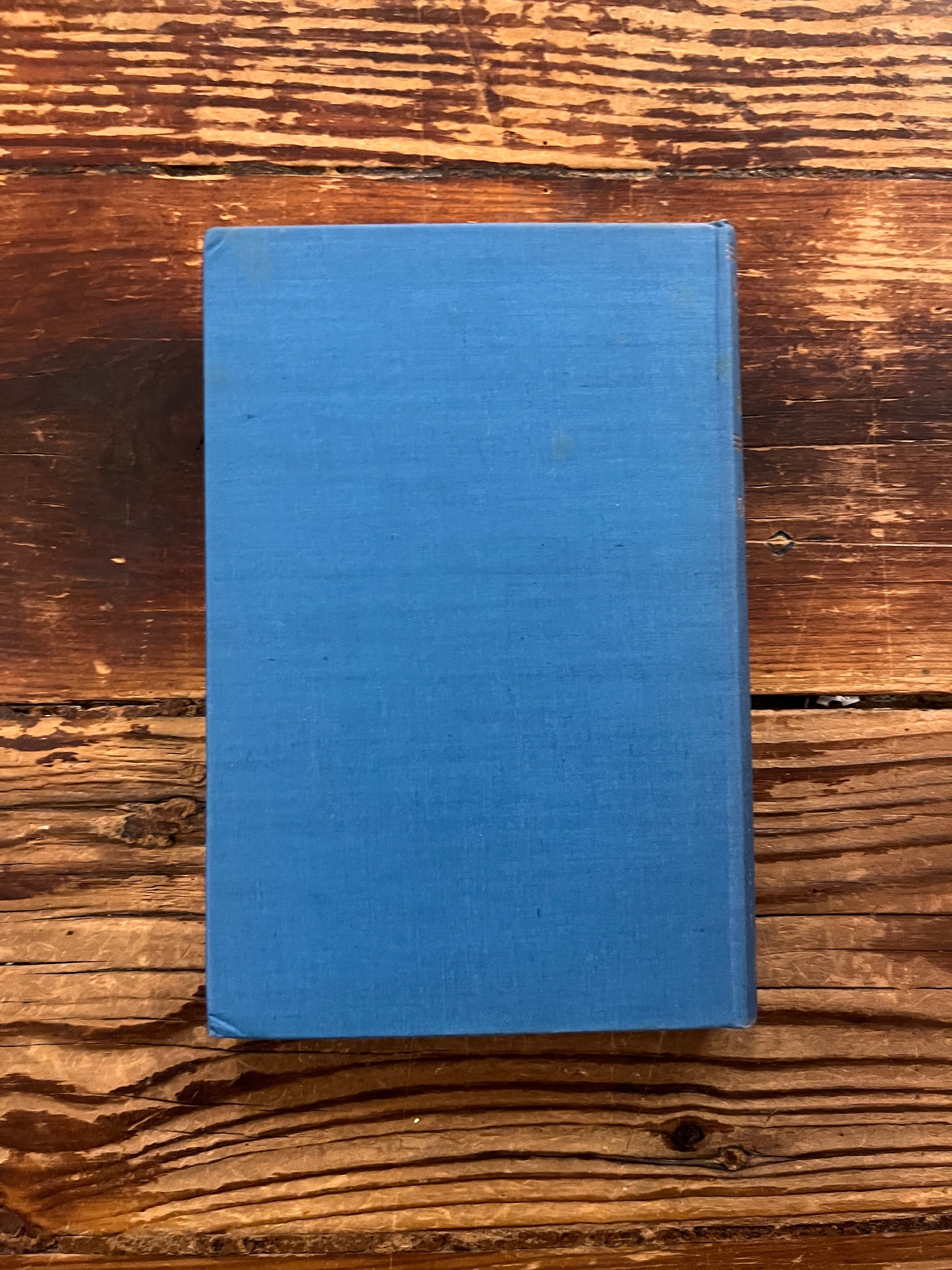 back side of book titled 'Strange Life of Ivan Osokin' by P.D. Ouspensky on a wooden surface