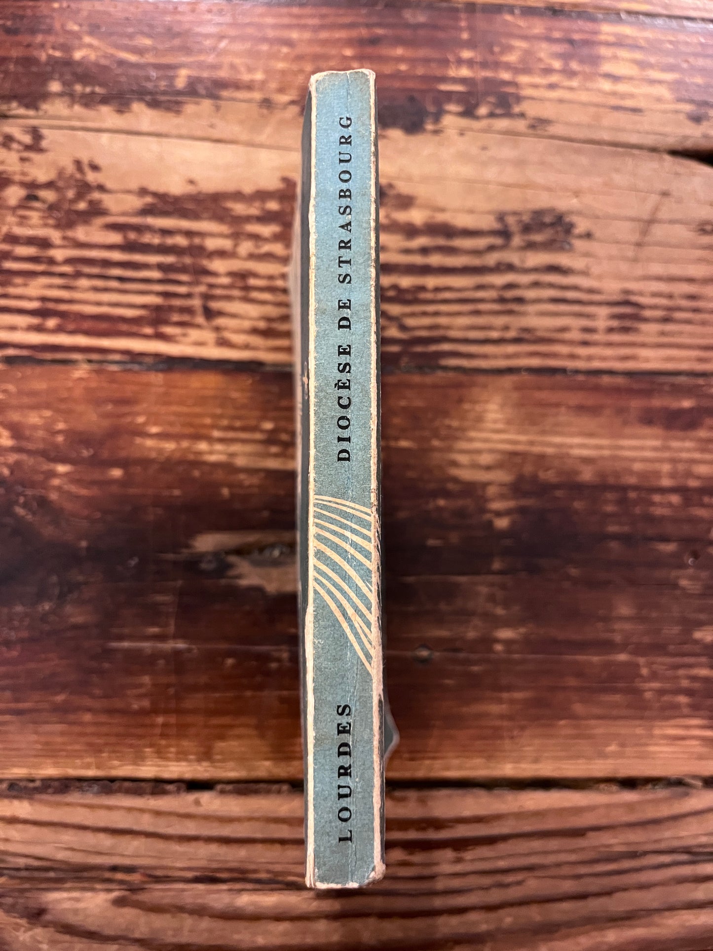 photo du dos du livre "manuel du pelerin" sur fond de bois