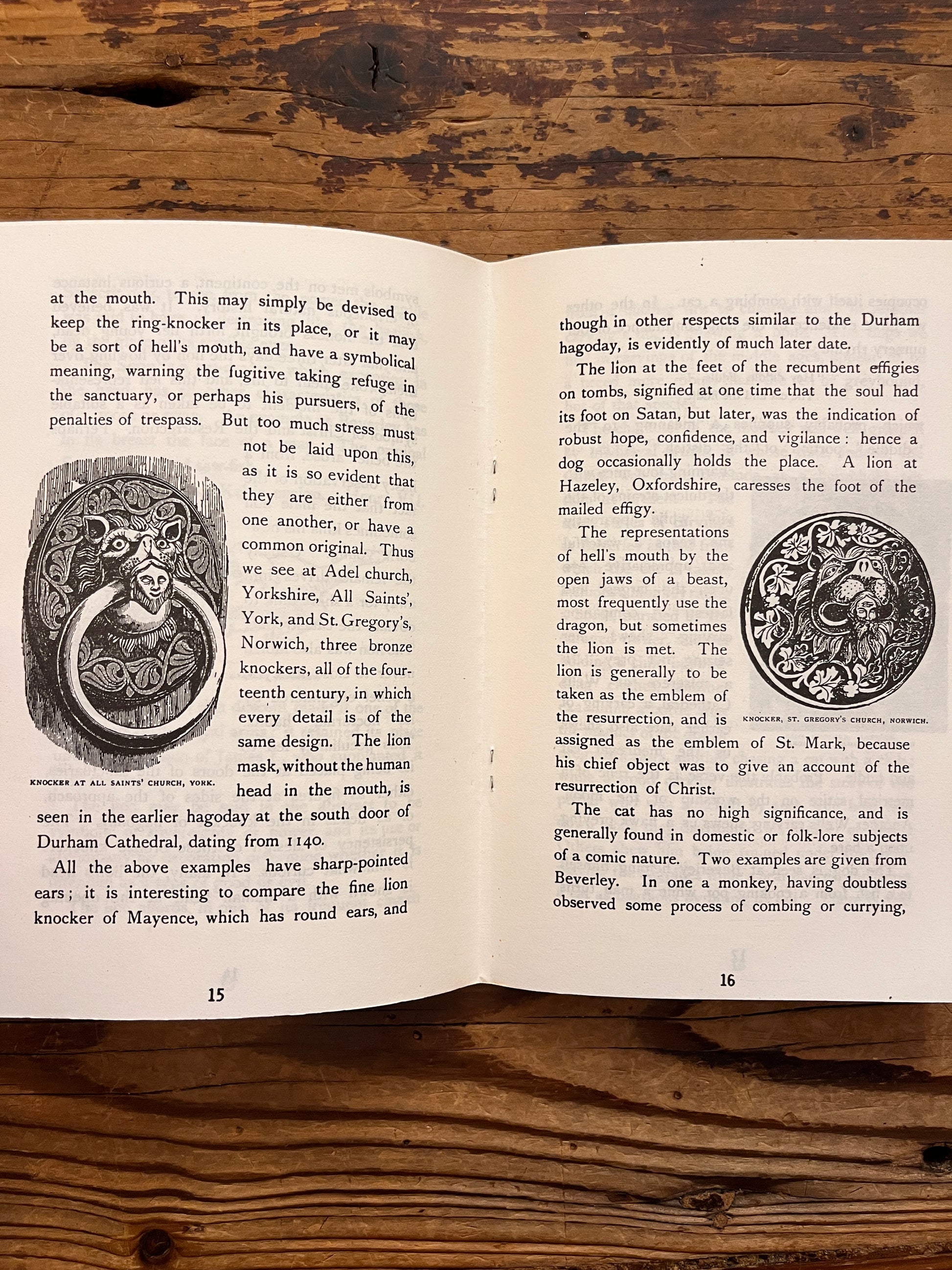 Open booklet with the title 'Animals of the chruch' by T. Tindall Wildridge on a ooden surface 