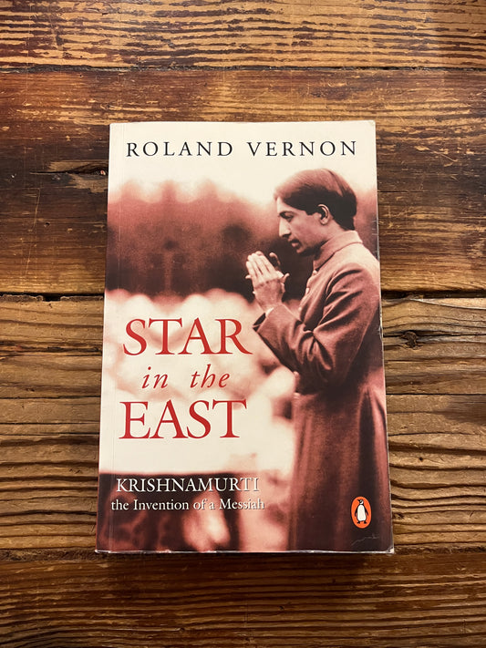 Book titled 'star in the East, Krishnamurti' by Roland Vernon on a wooden surface