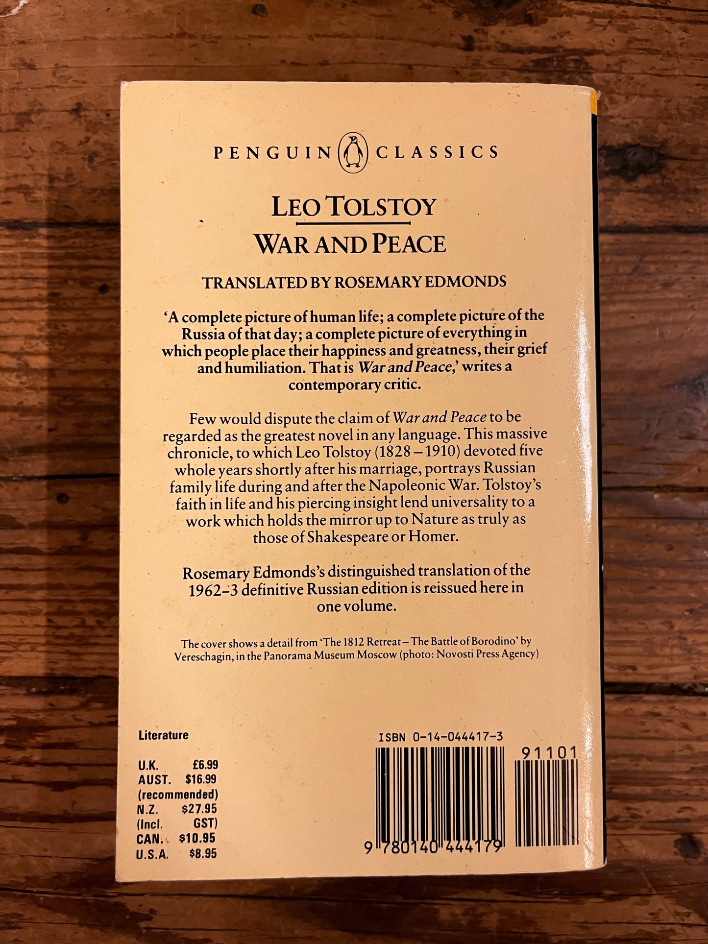 photo of the back cover of the book "war and peace" on a wooden background