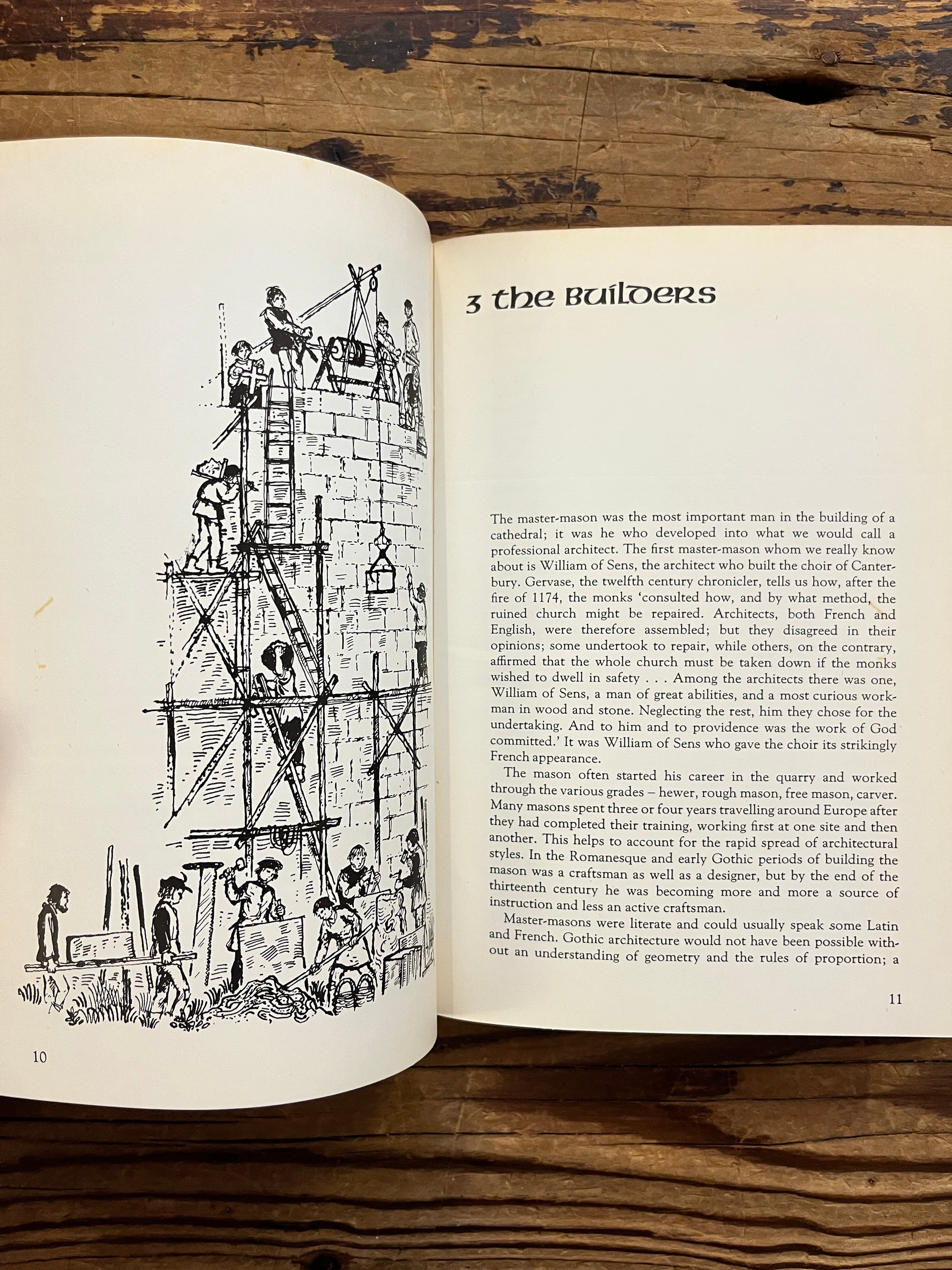 Open book titled 'Canterbury: the story of a cathedral' lying on a wooden surface 