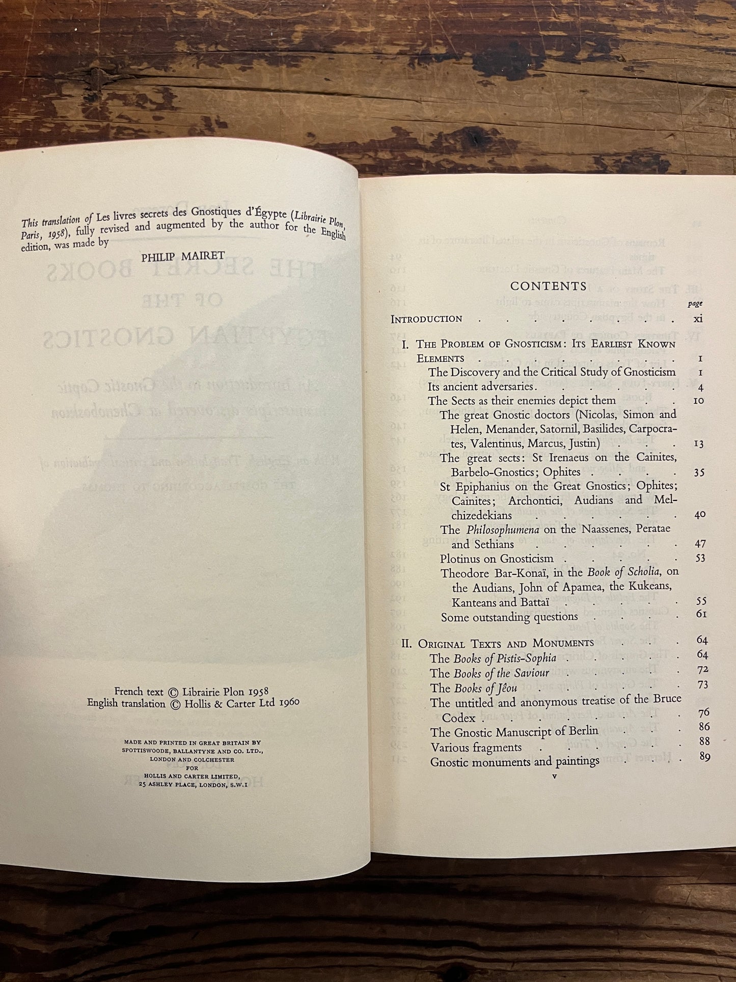 Open book titled 'The Secret Books of the Egyptian Gnostics' by Jean Doresse on a wooden surface