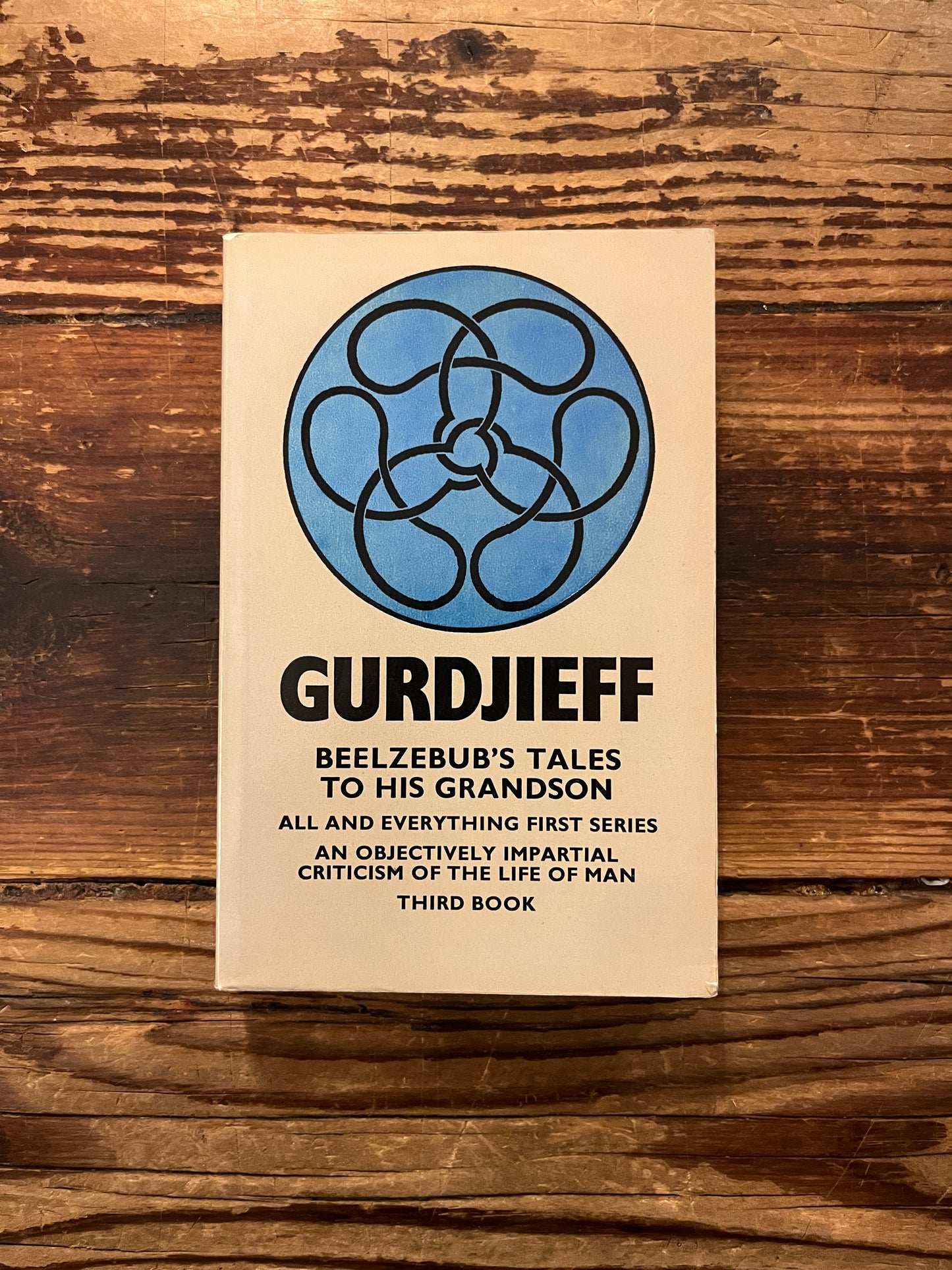 Front cover of 'beelzebub's tales to his grandson by Gurdjieff on a wooden surface