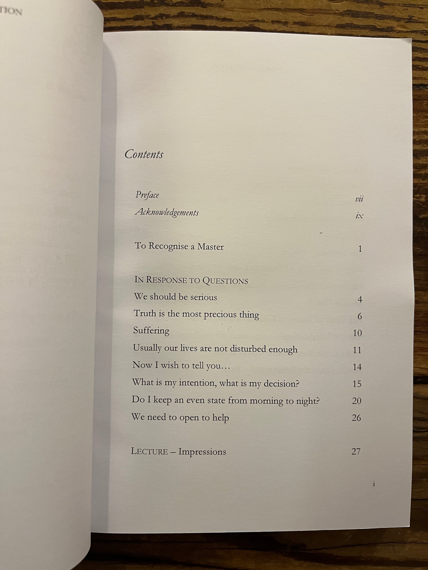 Open book titled 'Inside a Question' by Henriette Lannes on a wooden surfac