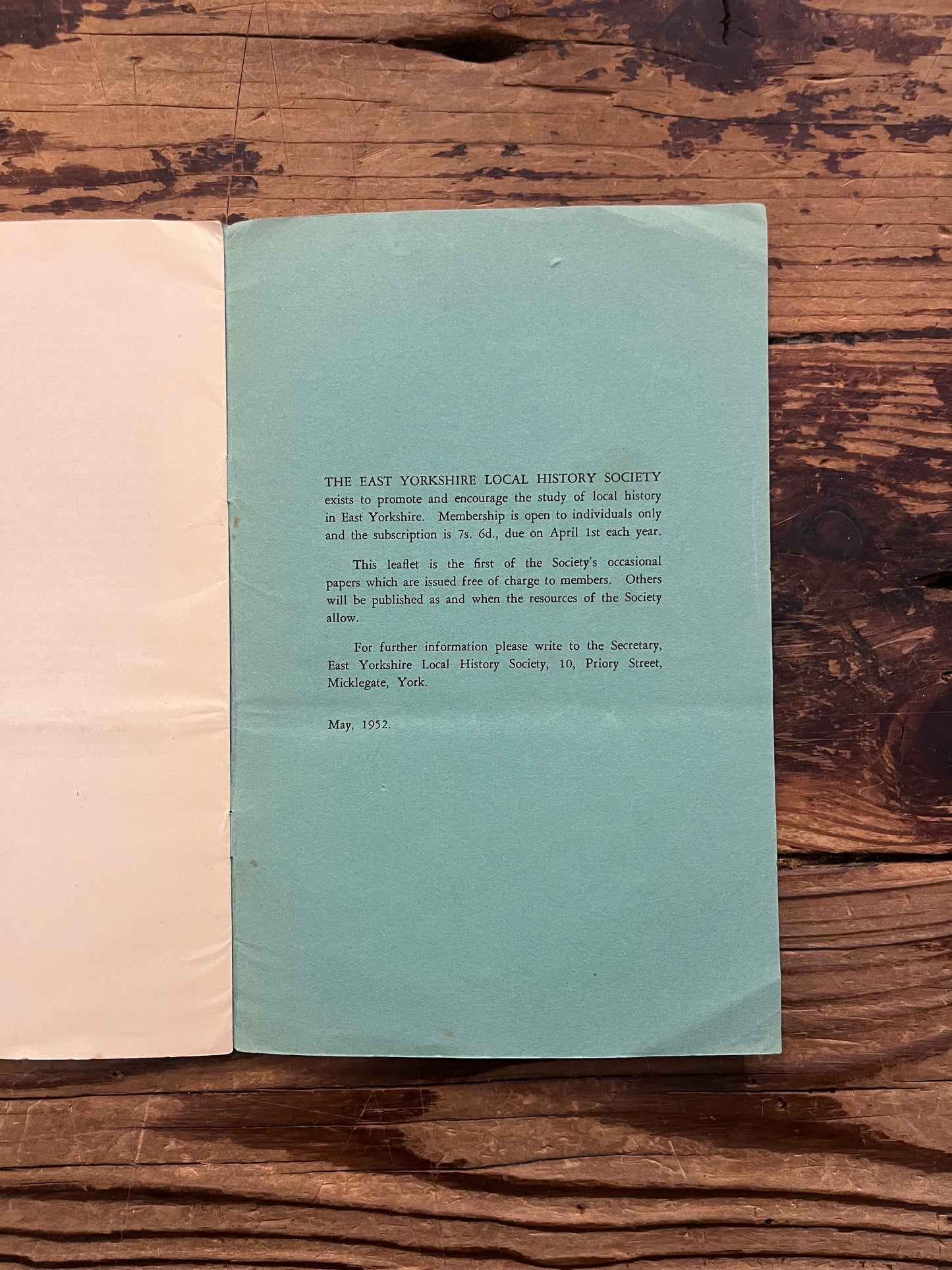 Open book titled 'Masons' Marks' by F.W. Brooks on a wooden surface