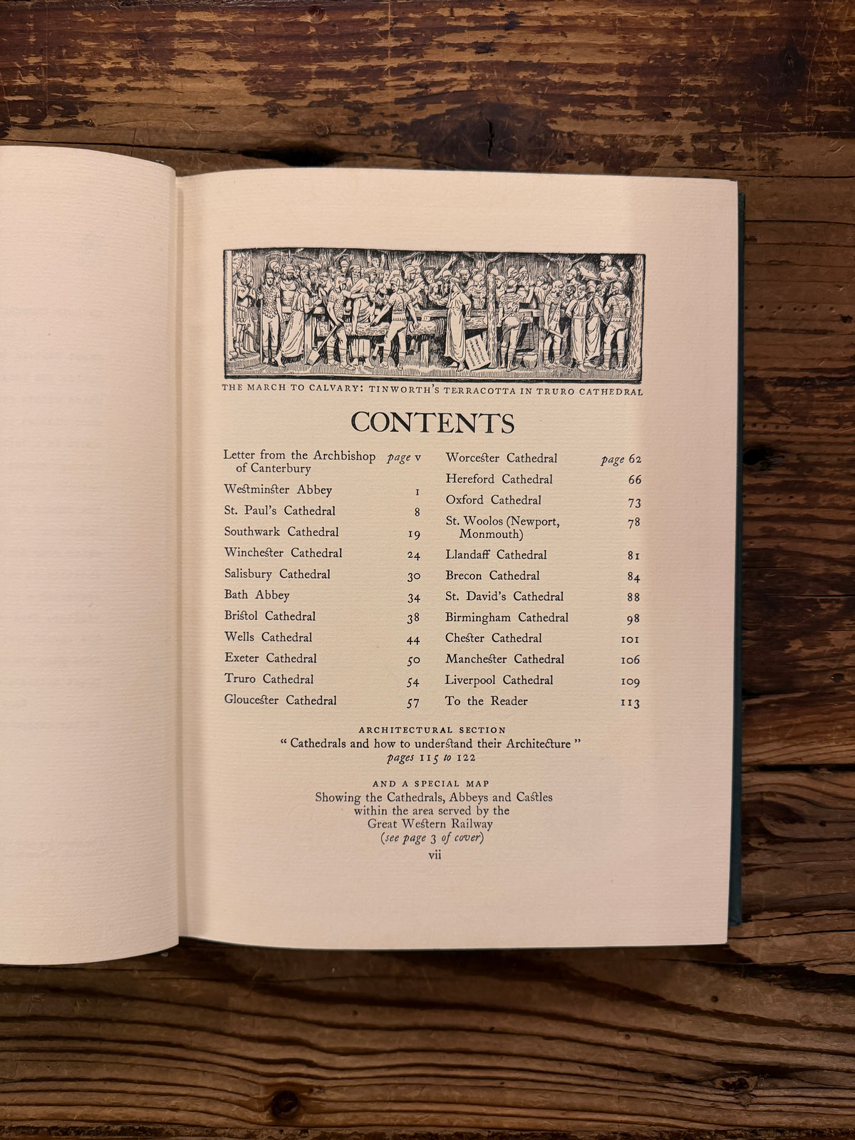 Open book titled 'Cathedrals' from 1926 from the series made by 'The Great Western Railway' on a wooden surface