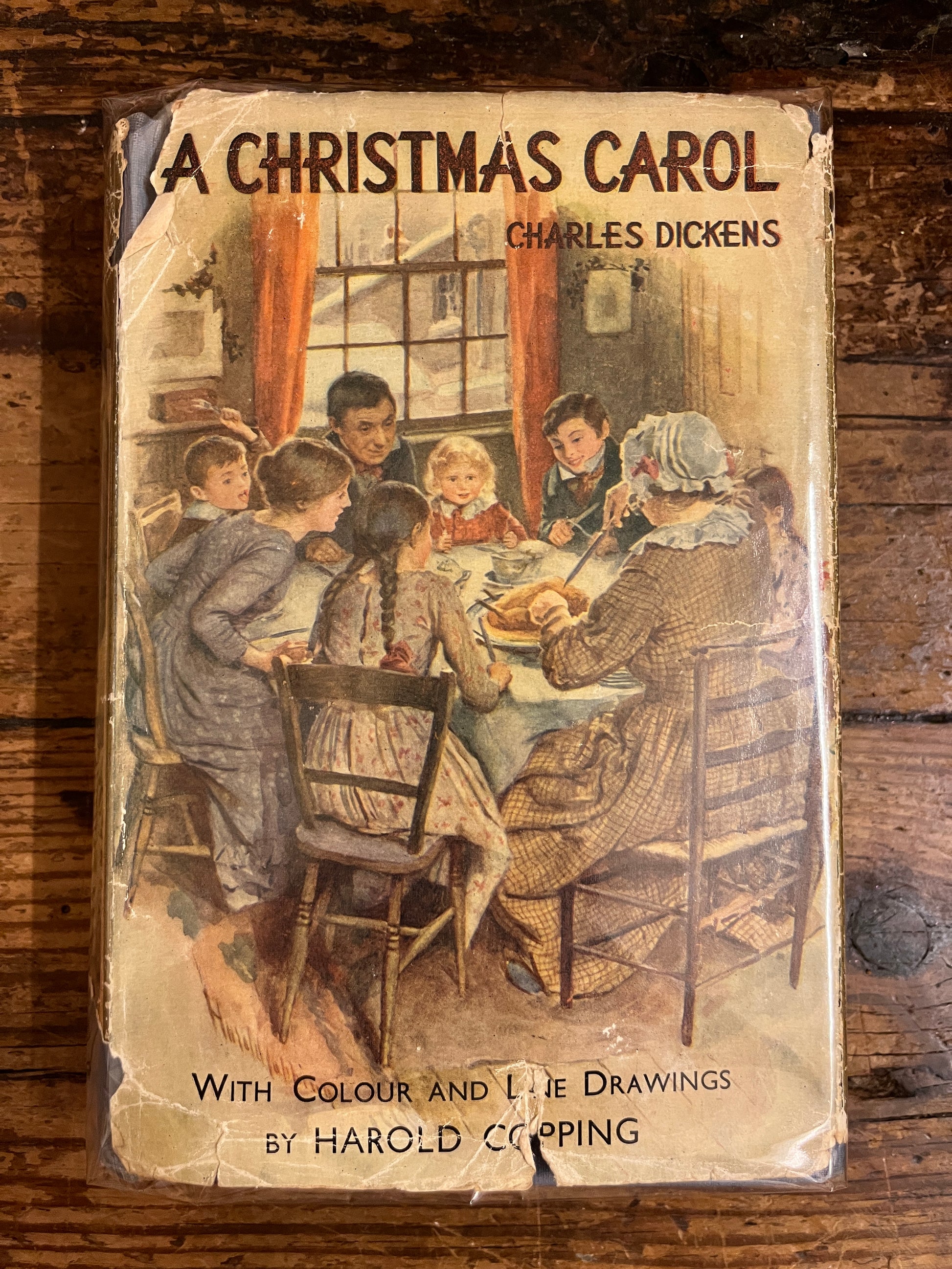 front cover of the book "A christmas Carol" on wooden background