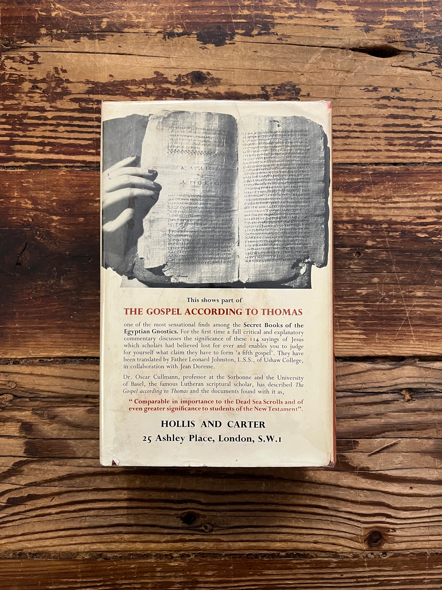 Back cover of book titled 'The Secret Books of the Egyptian Gnostics' by Jean Doresse on a wooden surface