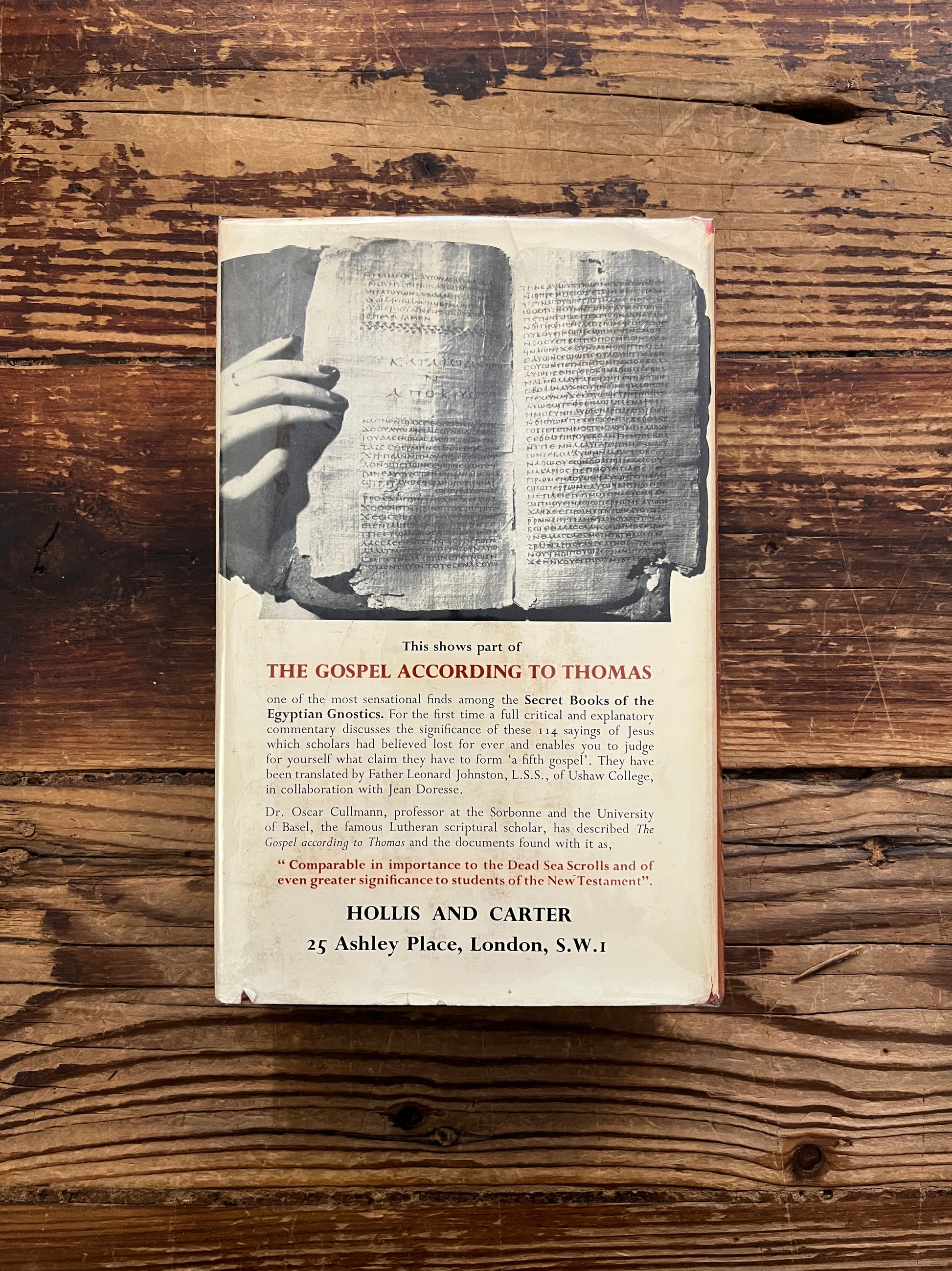 Back cover of book titled 'The Secret Books of the Egyptian Gnostics' by Jean Doresse on a wooden surface