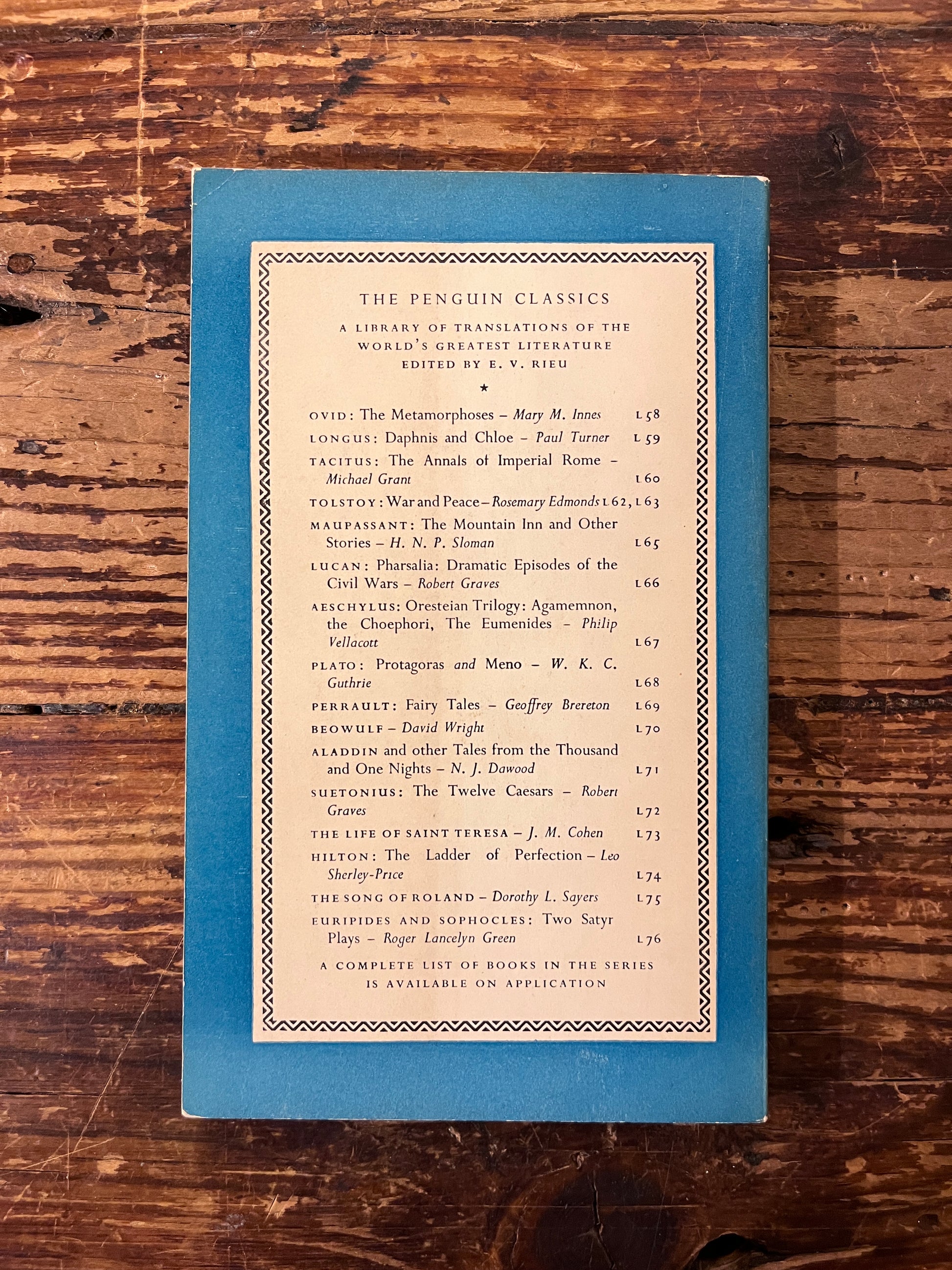 photo of the backcover of the book " Galateo"  on a wooden background