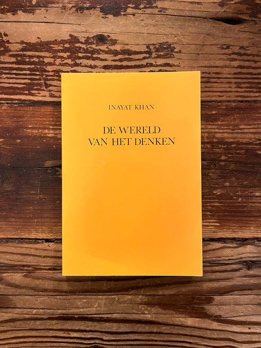 Voorkant van boek 'De Wereld van het Denken'  door Inayat Khan on a wooden surface