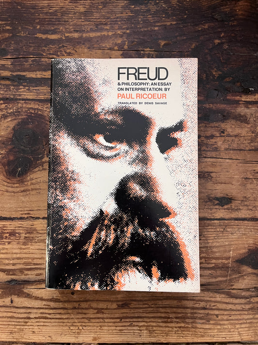 photo of the cover of the book "Freud and philosophy" on a wooden background