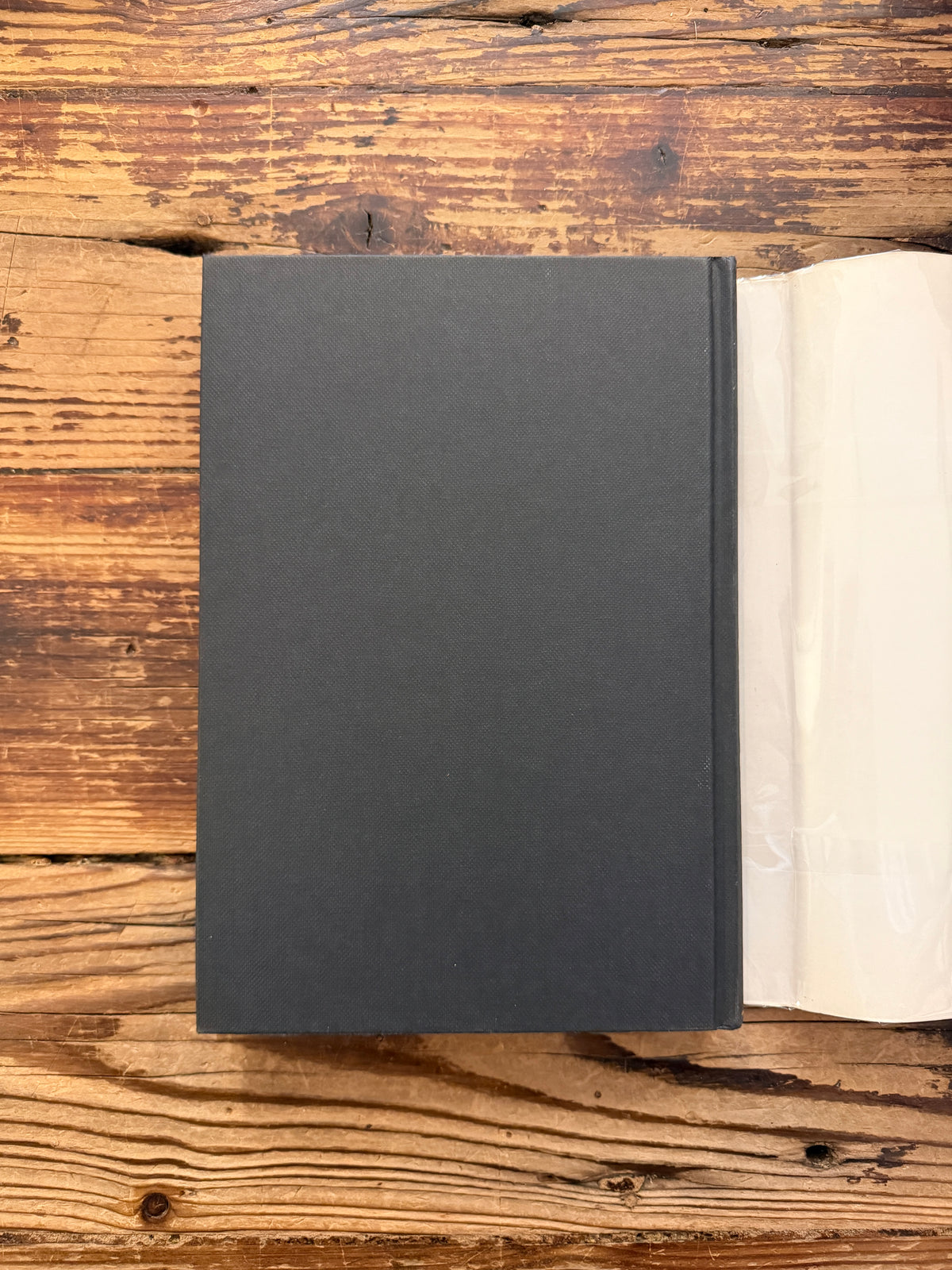 Back cover without dust jacket of a book titled 'Life in Medieval France' by Joan Evans, on a wooden surface