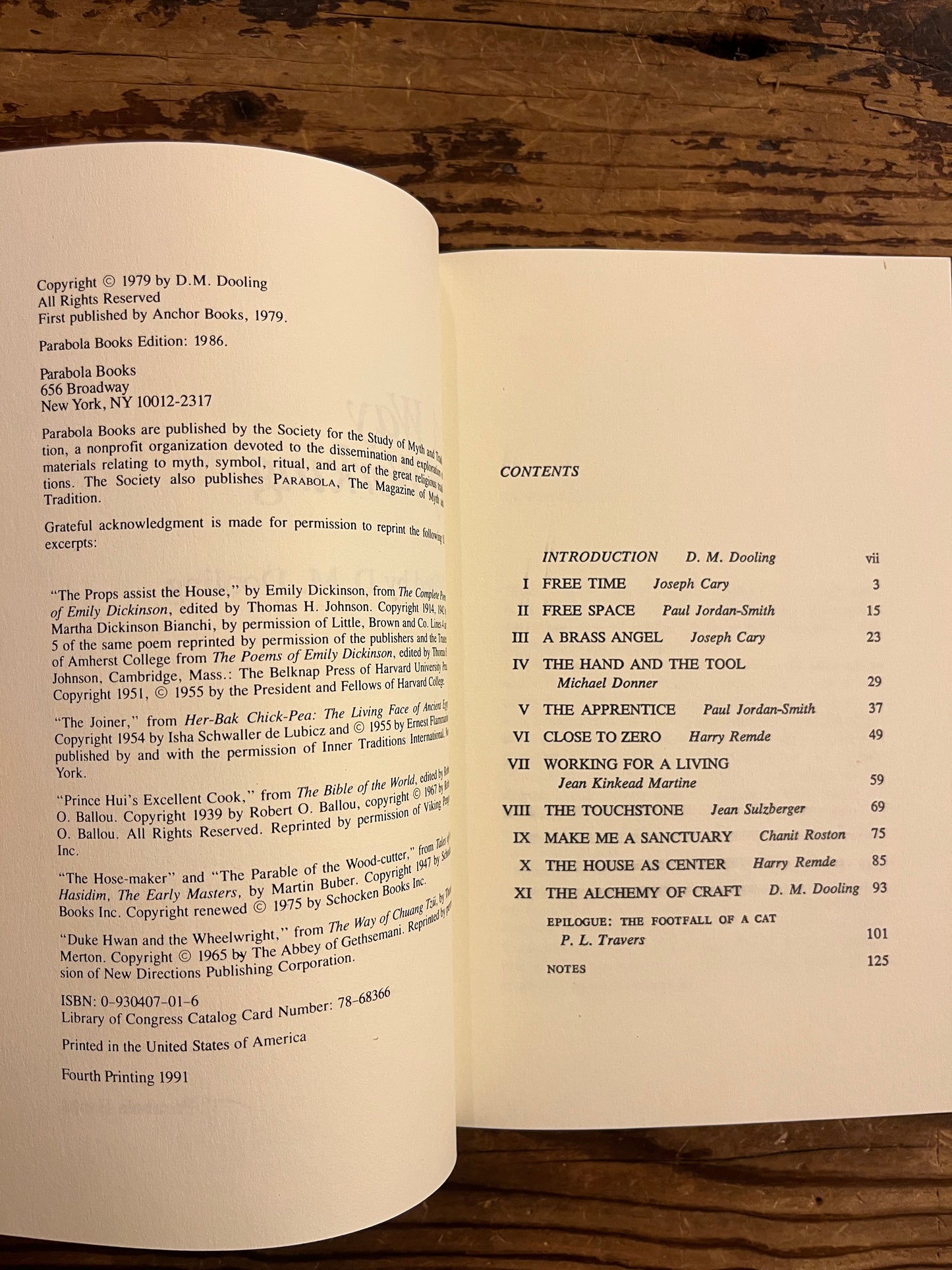 Open book titled ' A way of working, the spiritual dimension of craft' on a wooden surface