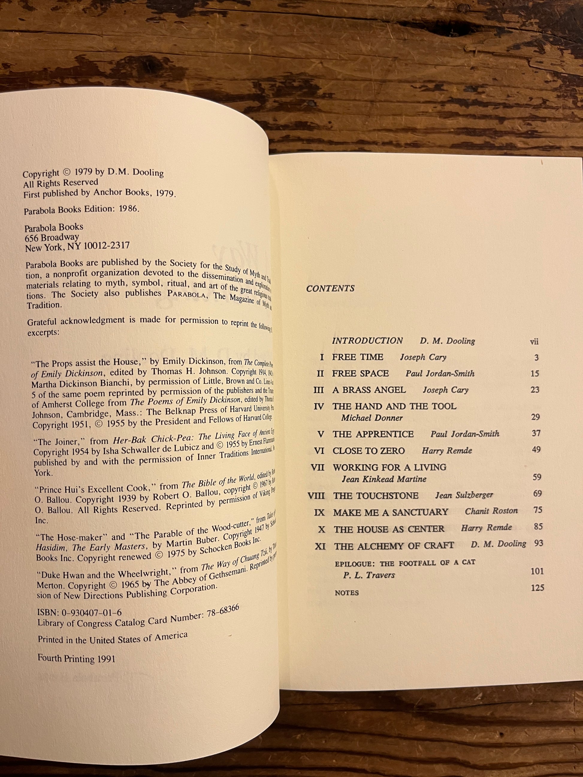 Open book titled ' A way of working, the spiritual dimension of craft' on a wooden surface