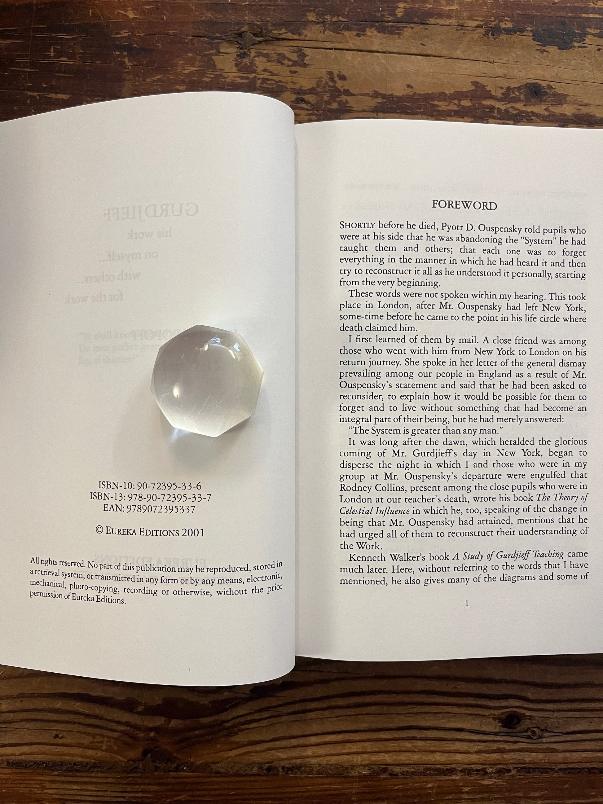 Open book titled 'Gurdjieff, His work, on myself, with others, for the work' by Irmis B. Popoff on a wooden surface