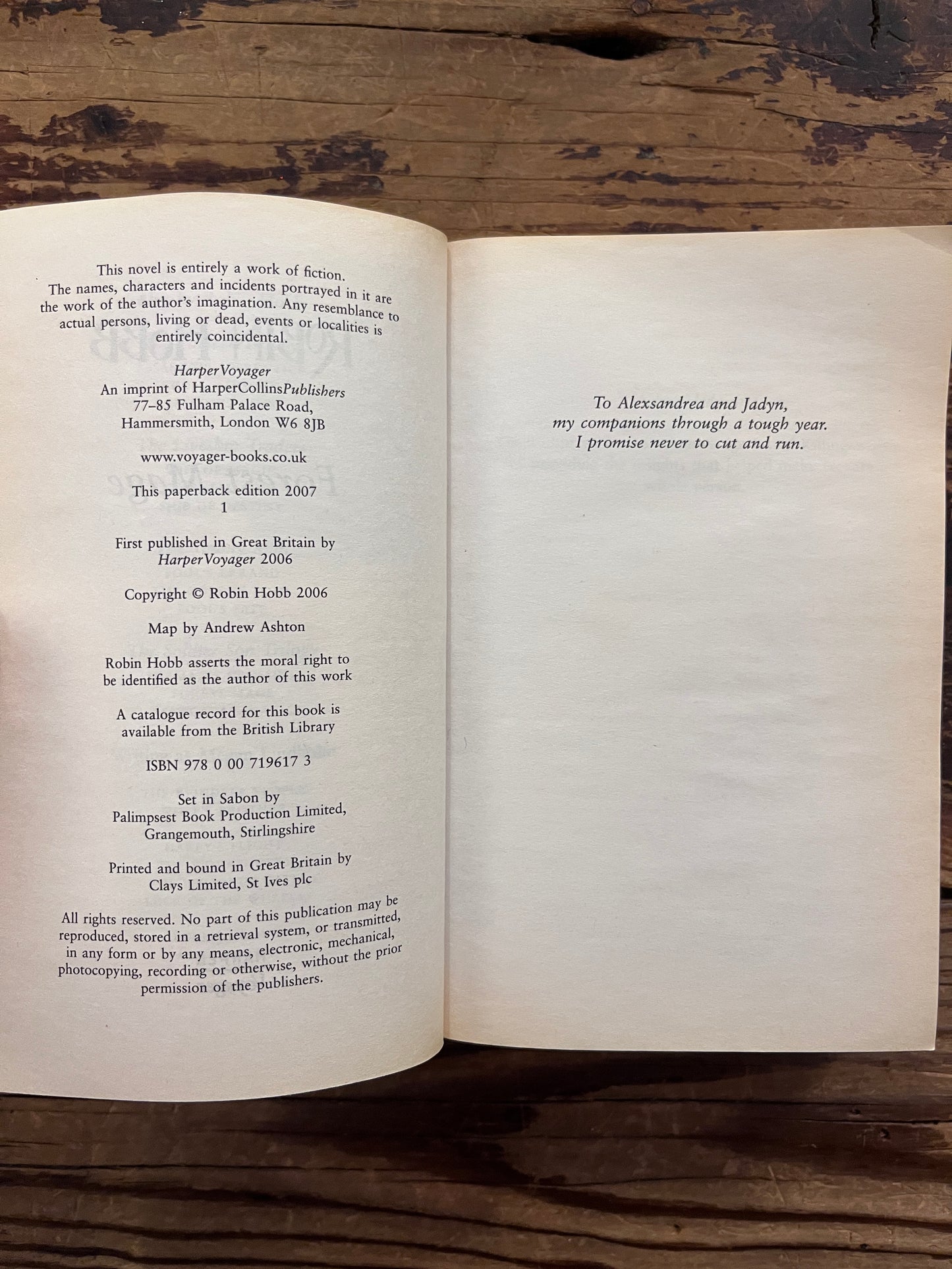 Open Book titled 'Forest Mage' by Robin Hobb on a wooden surface