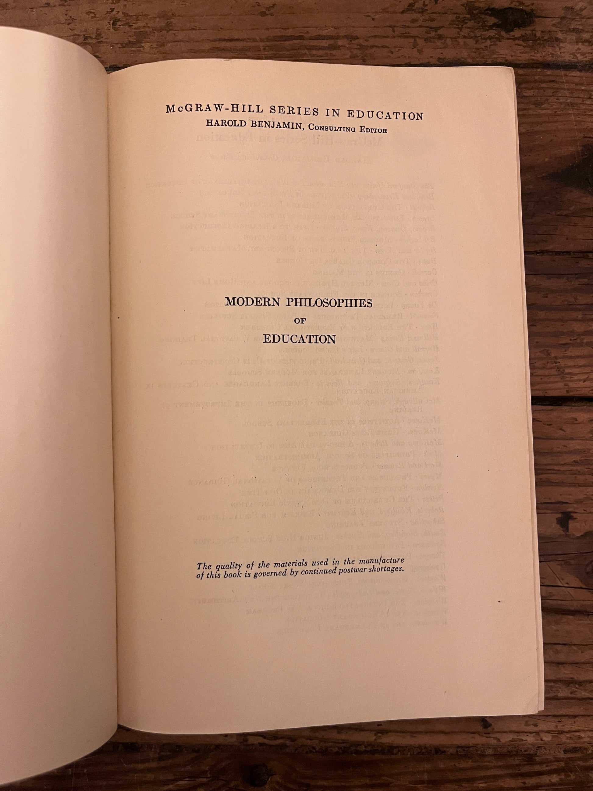 photo of the title page of the book "modern philosophies of educatio" on a wooden baclground