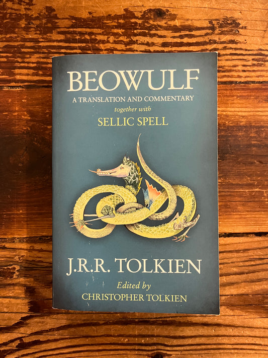 Book titled 'Beowulf' by J.R.R. Tolkien on a wooden surface