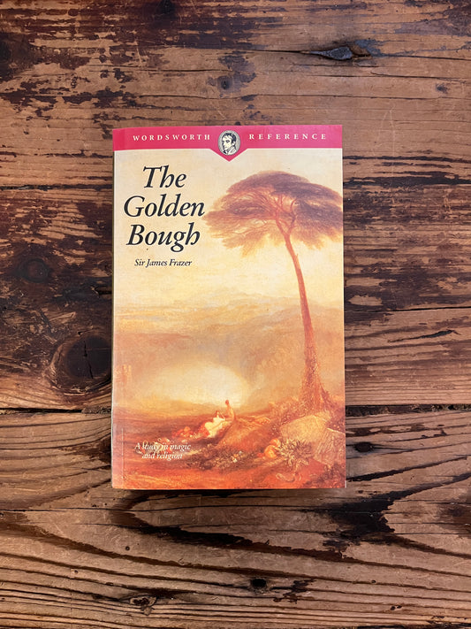 Front cover of book titled 'The Golden Bough' by James G. Frazer on a wooden surface