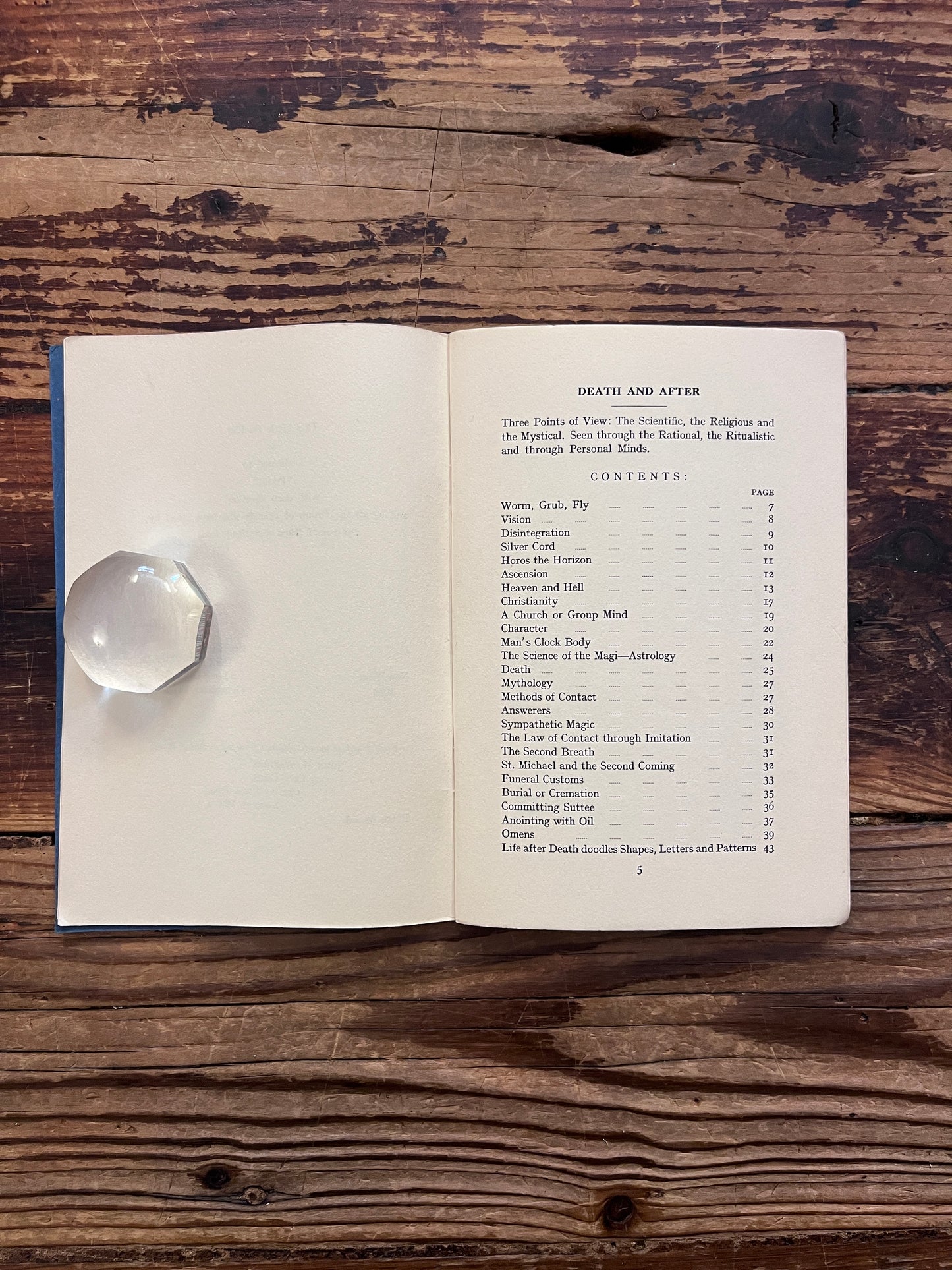 Open booklet showing the contents of booklet with the title 'Death and After' by Minnie B. Theobald on a wooden surface 
