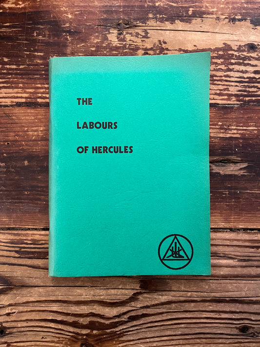 Front cover of book titled 'The Labours of Hercules' by Alice A. Bailey on a wooden surface