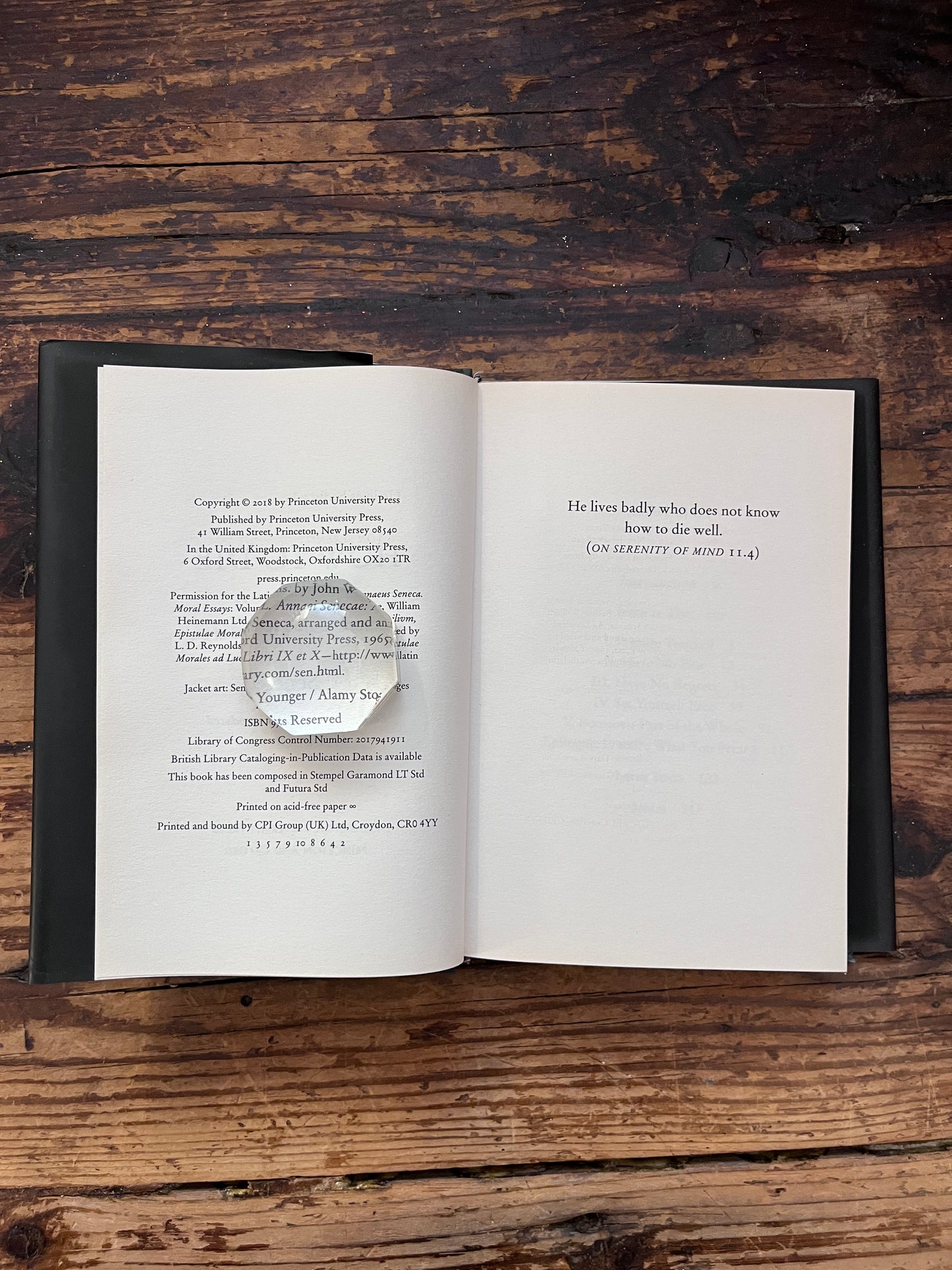 photo of the half title page of the book "how to die" on a wooden background