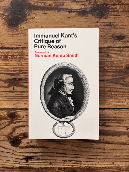 photo of the cover of the book "Immanuel's kant critique of reason" on wooden background