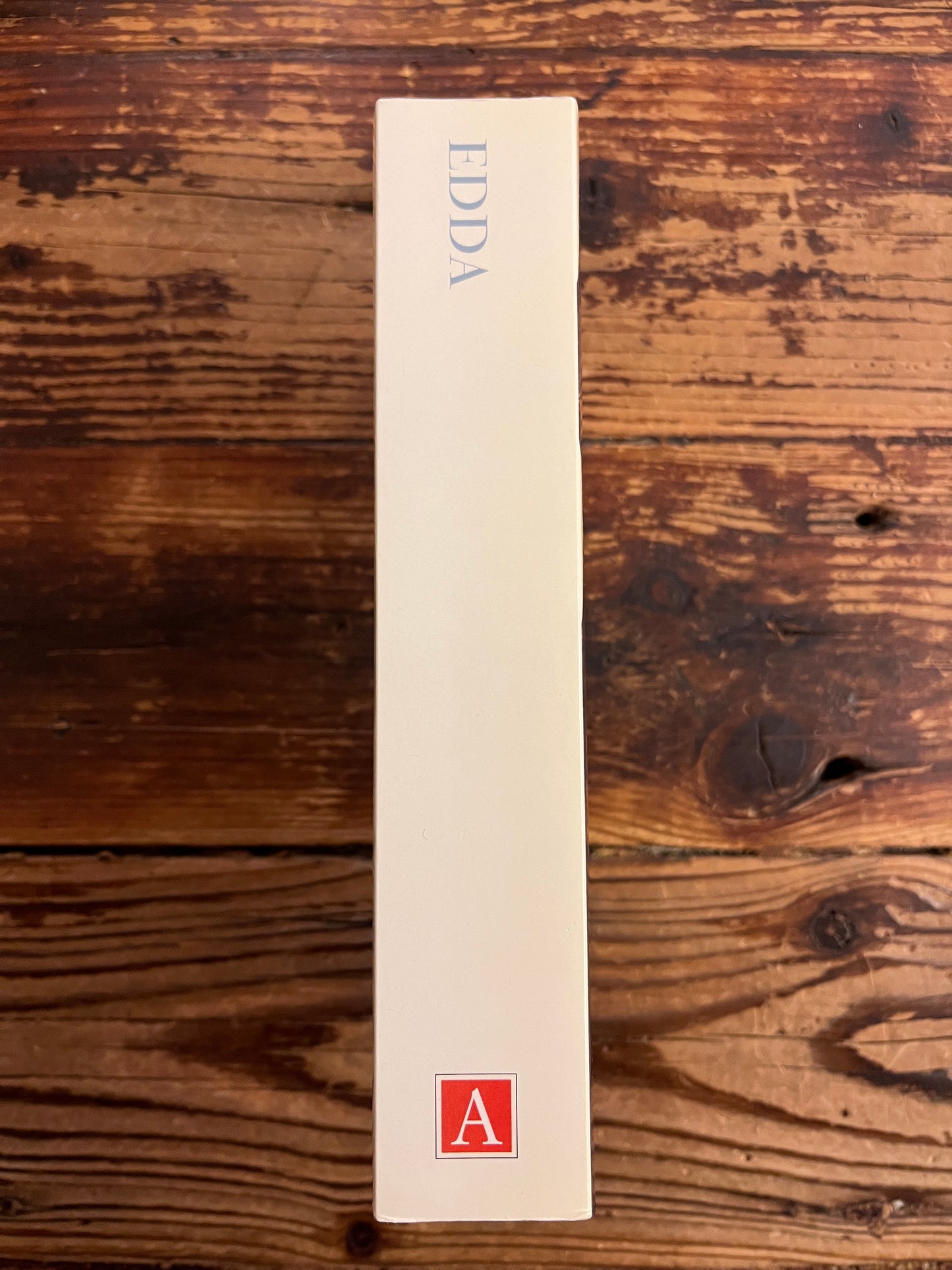 book spine with the title EDDA on a wooden surface 