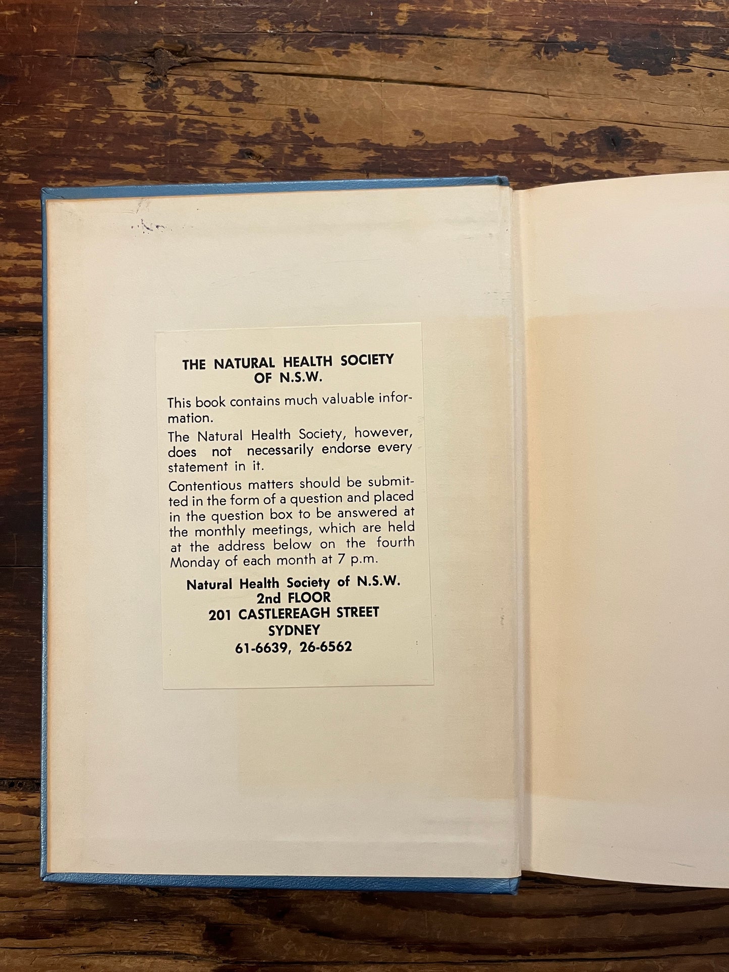 Open book titled 'Rubies in the Sand' by Herbert M. Shelton on a wooden surface