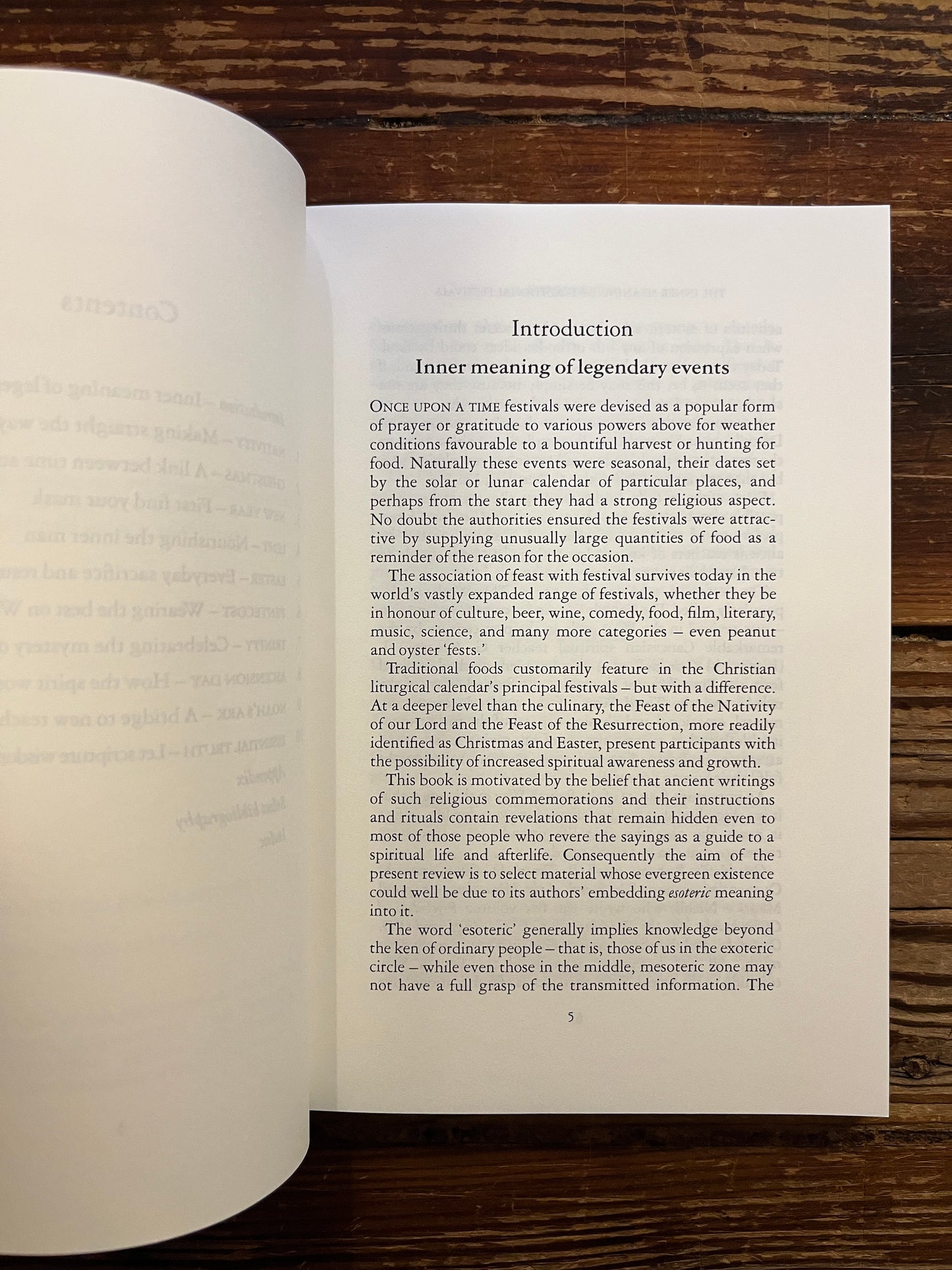 Open book titled 'The Inner Meaning of Traditional Festivals' by Bob Hunter on a wooden surface