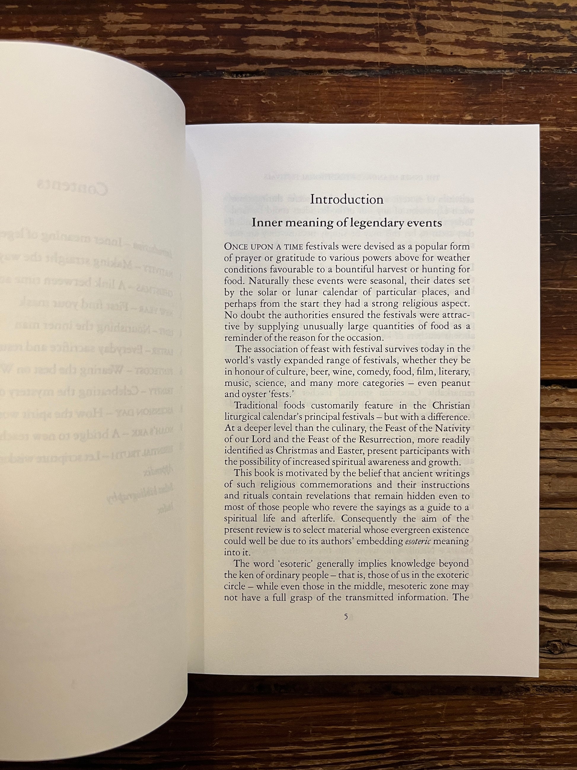 Open book titled 'The Inner Meaning of Traditional Festivals' by Bob Hunter on a wooden surface