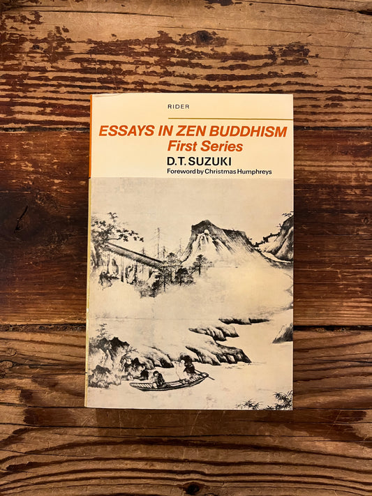 Front cover of book titled 'Essays in Zen Buddhism' by D.T. Suzuki on a wooden surface
