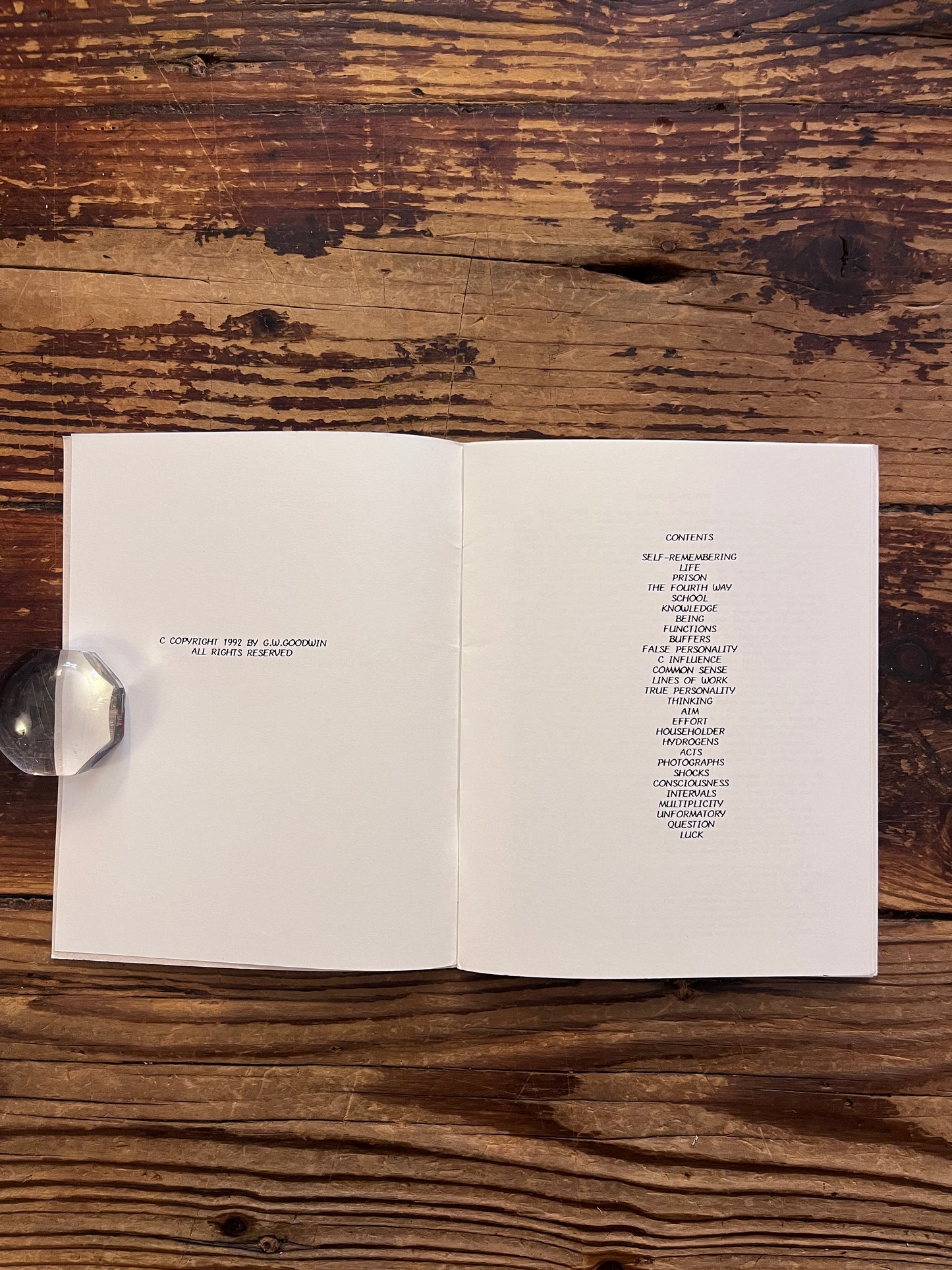 Open booklet with the title 'Gurdjieff Entrance and Introduction to the Fourth Way' on a wooden surface 