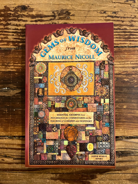 Front cover of a book with the title 'Gems of Wisdom' by Maurice Nicoll on a wooden surface