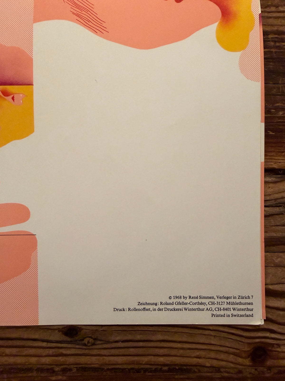 Details of fodable map designed by Roland Gfeller-Corthésy in the complete set of 'Simmen's Portfolio No. 1: Die glückliche Hand' on a wooden background 