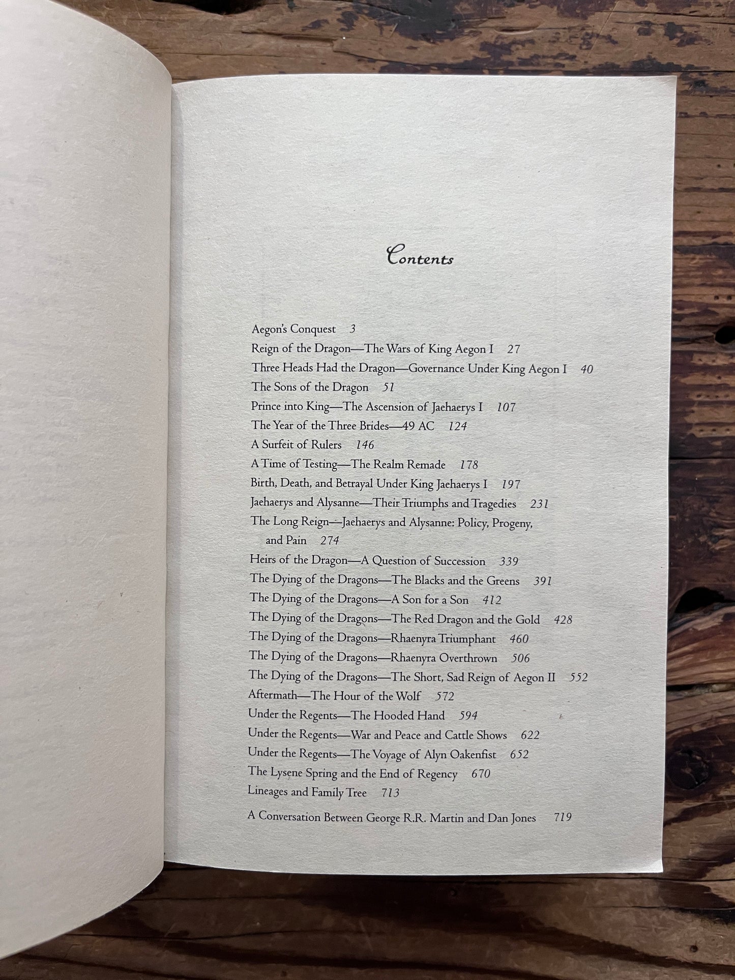 Book titled 'Fire and Blood' by George R.R. Martin on a wooden surface