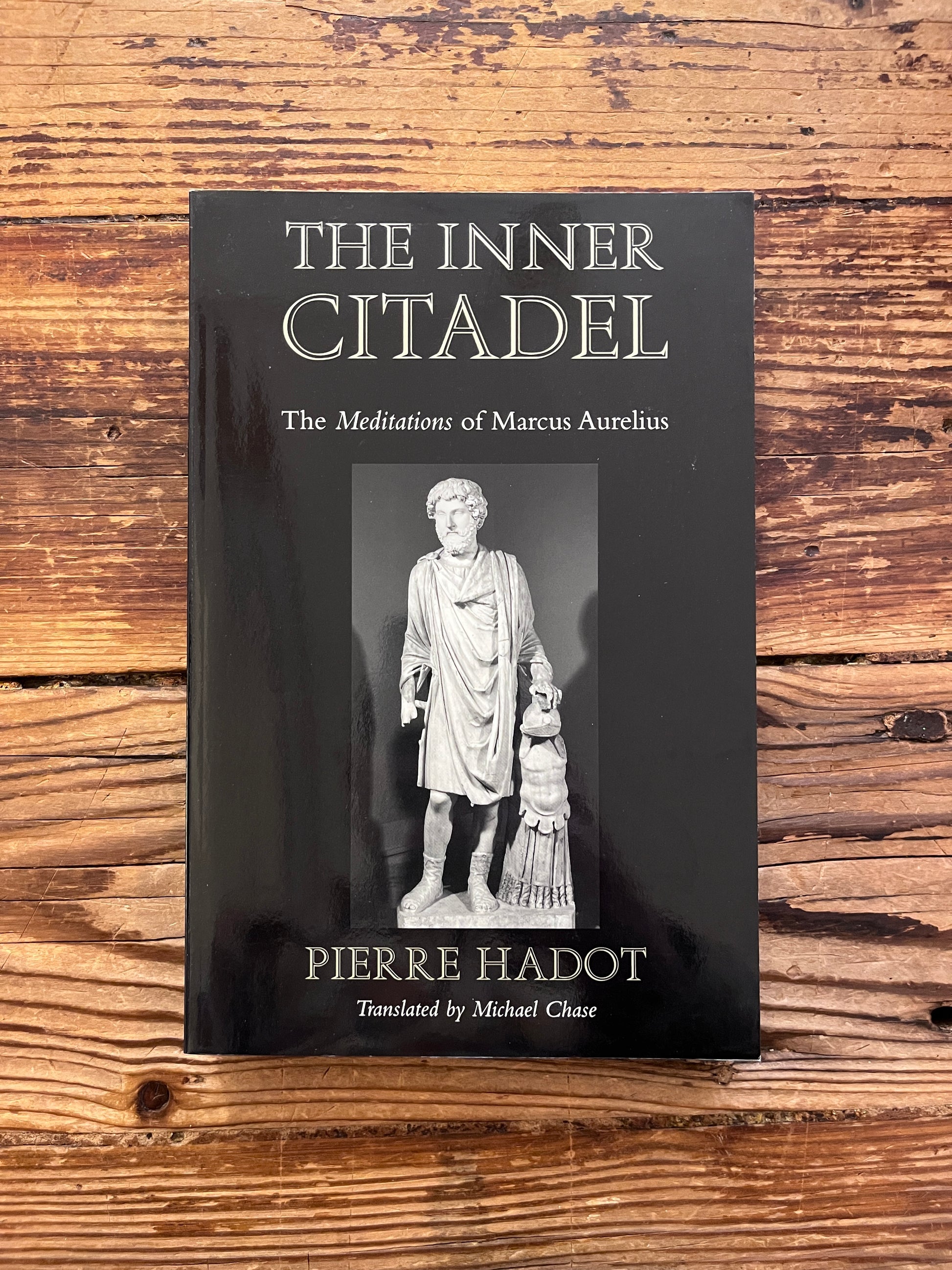 photo of the cover of the book "The inner citadel" on a wooden background
