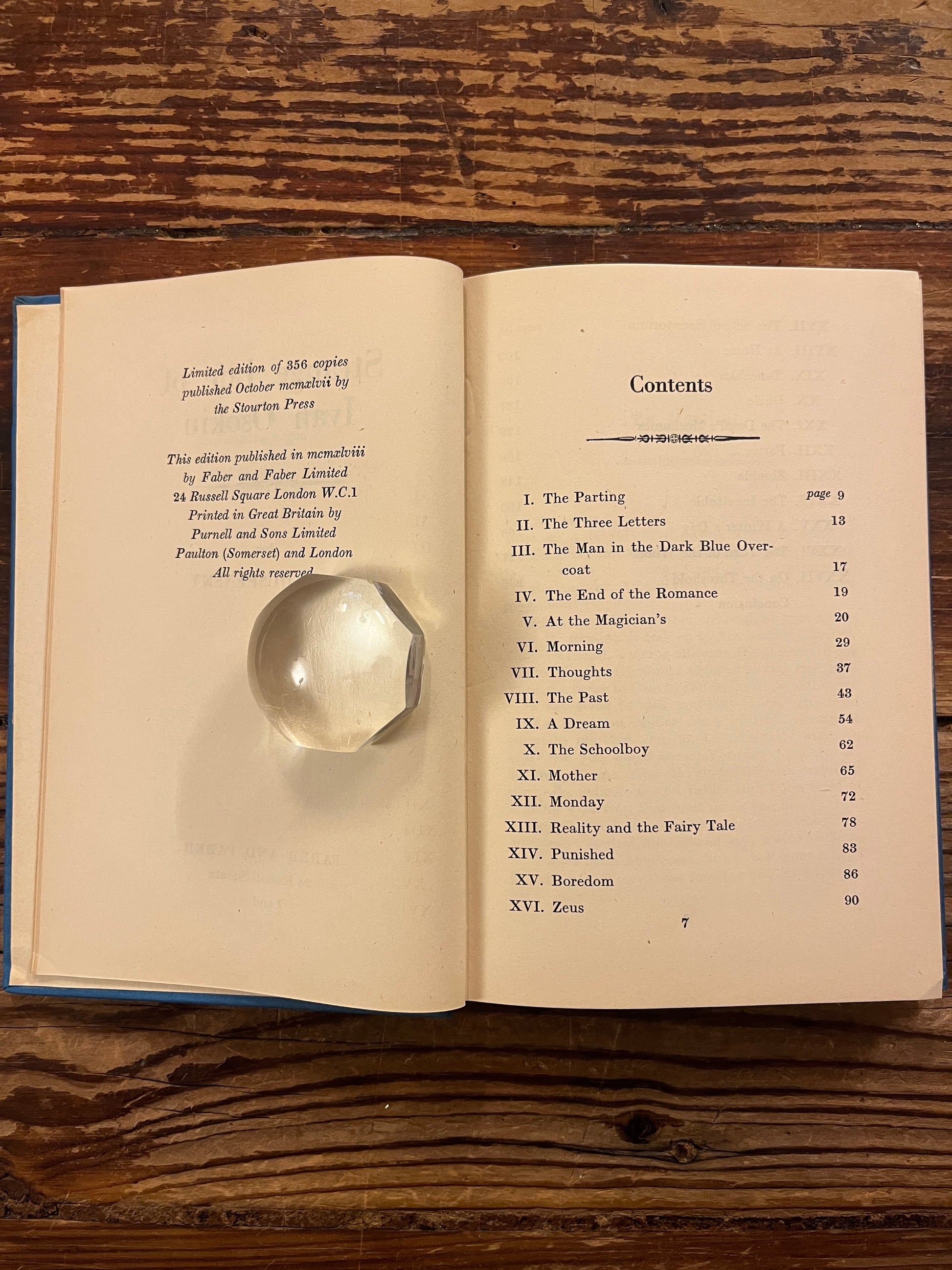 Open book titled 'Strange Life of Ivan Osokin' by P.D. Ouspensky on a wooden surface