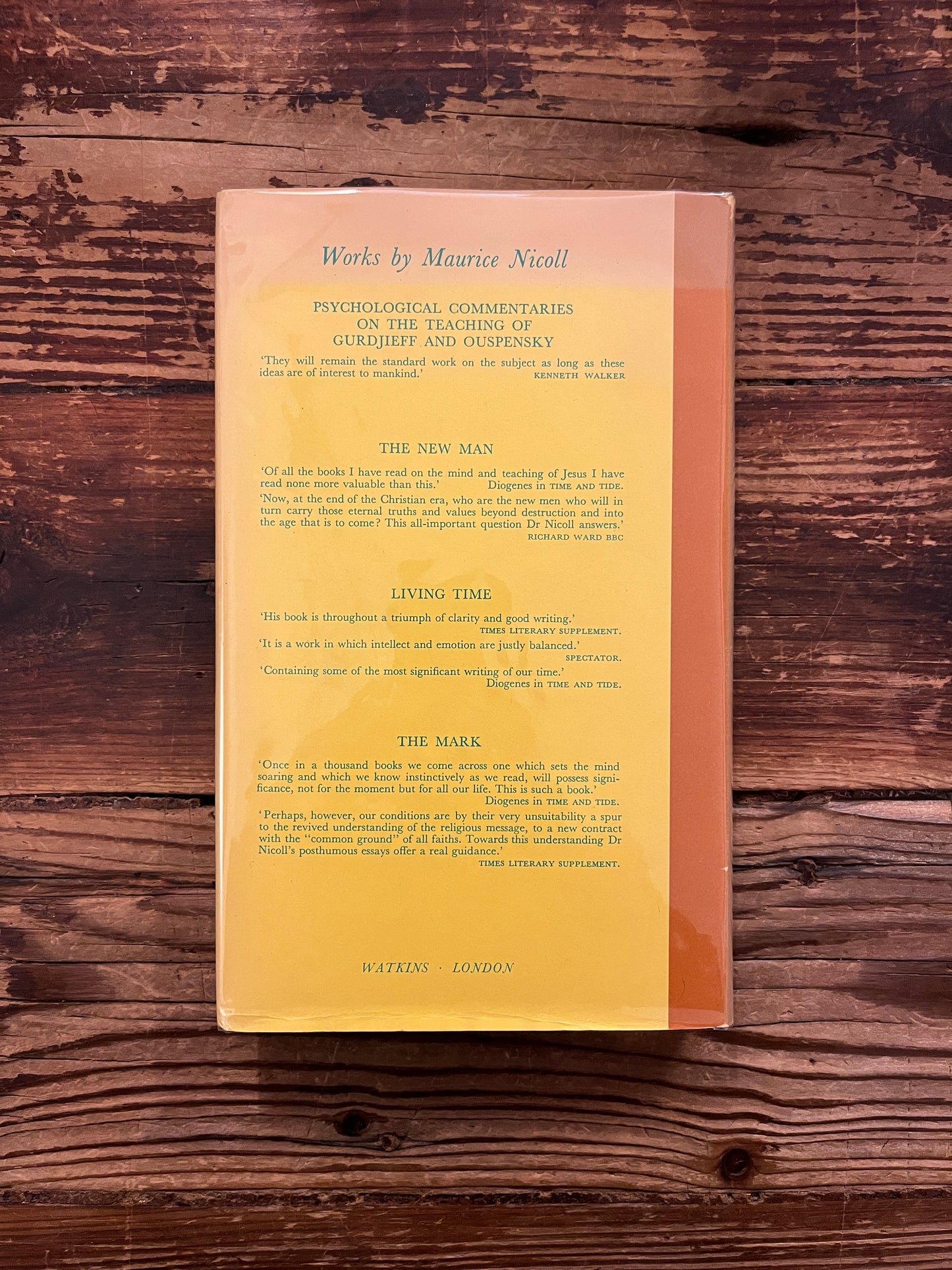 Back cover of book titled 'Psychological Commentaries on the Teaching of Gurdjieff & Ouspensky volume 4' by Maurice Nicoll on a wooden surface