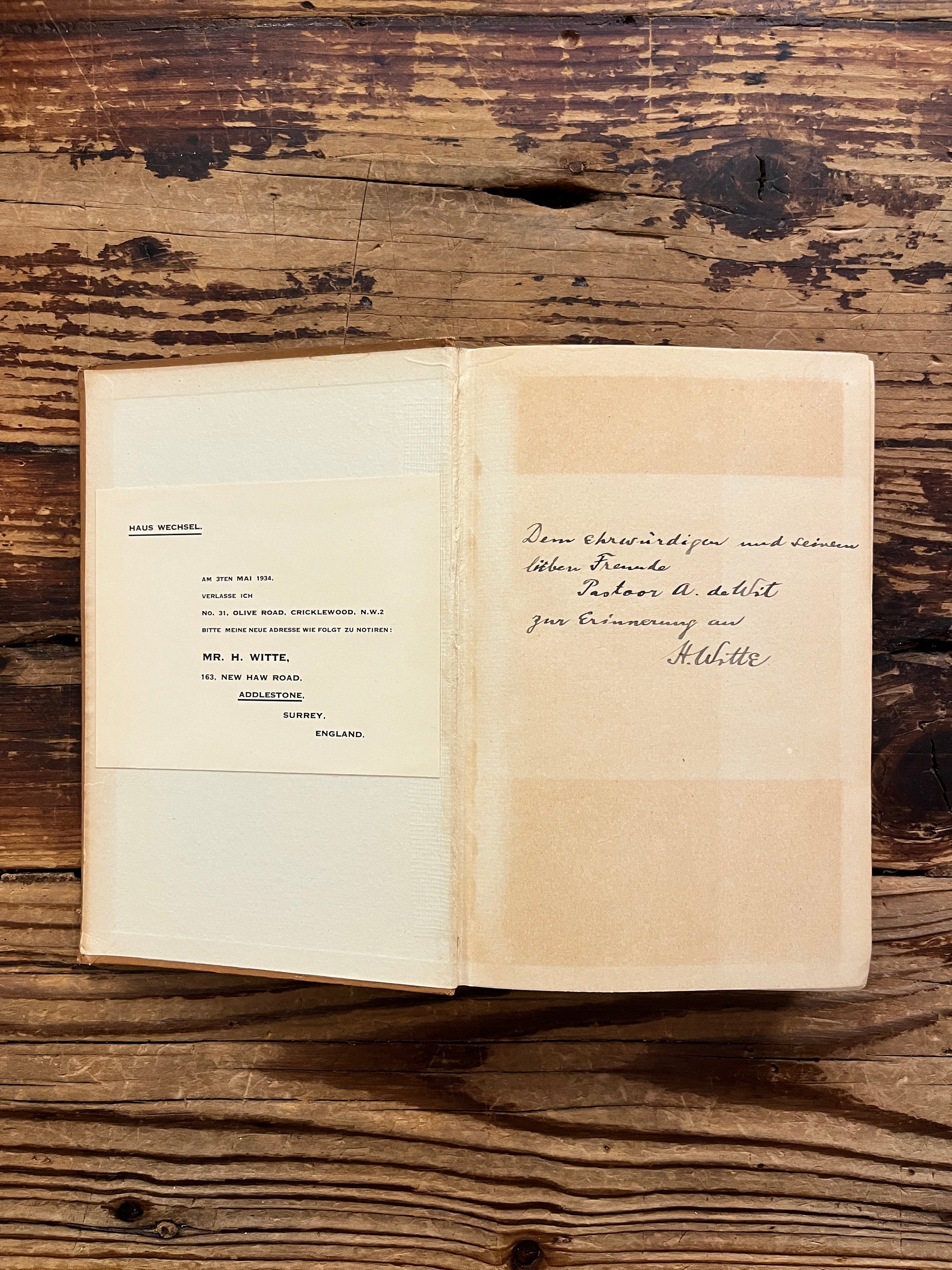 Open book with the title 'the gospels, fact, myth or legend ? by J.P. Arendzen Ph.D. on a wooden surface