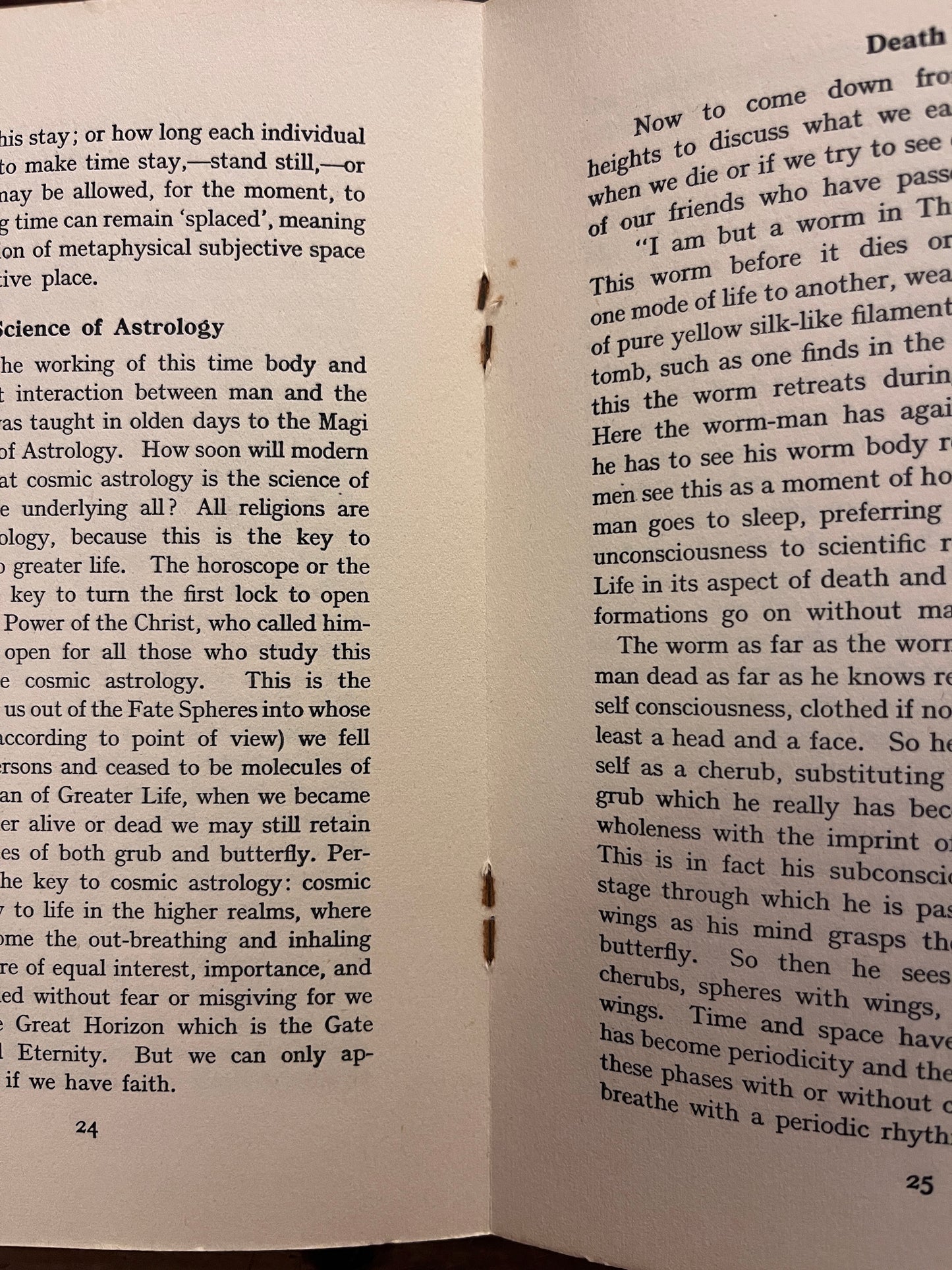Open booklet showing the lightly rusted staples of the booklet with the title 'Death and After' by Minnie B. Theobald on a wooden surface 