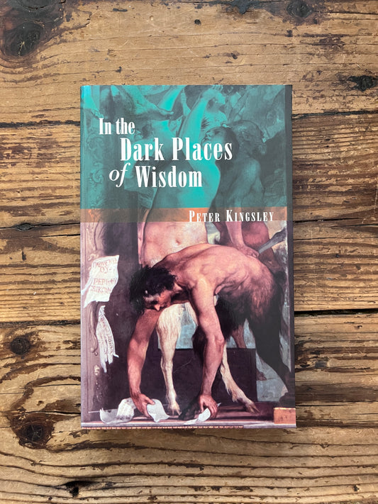 photo of the cover of the book "dark places of wisdom" on a wooden background