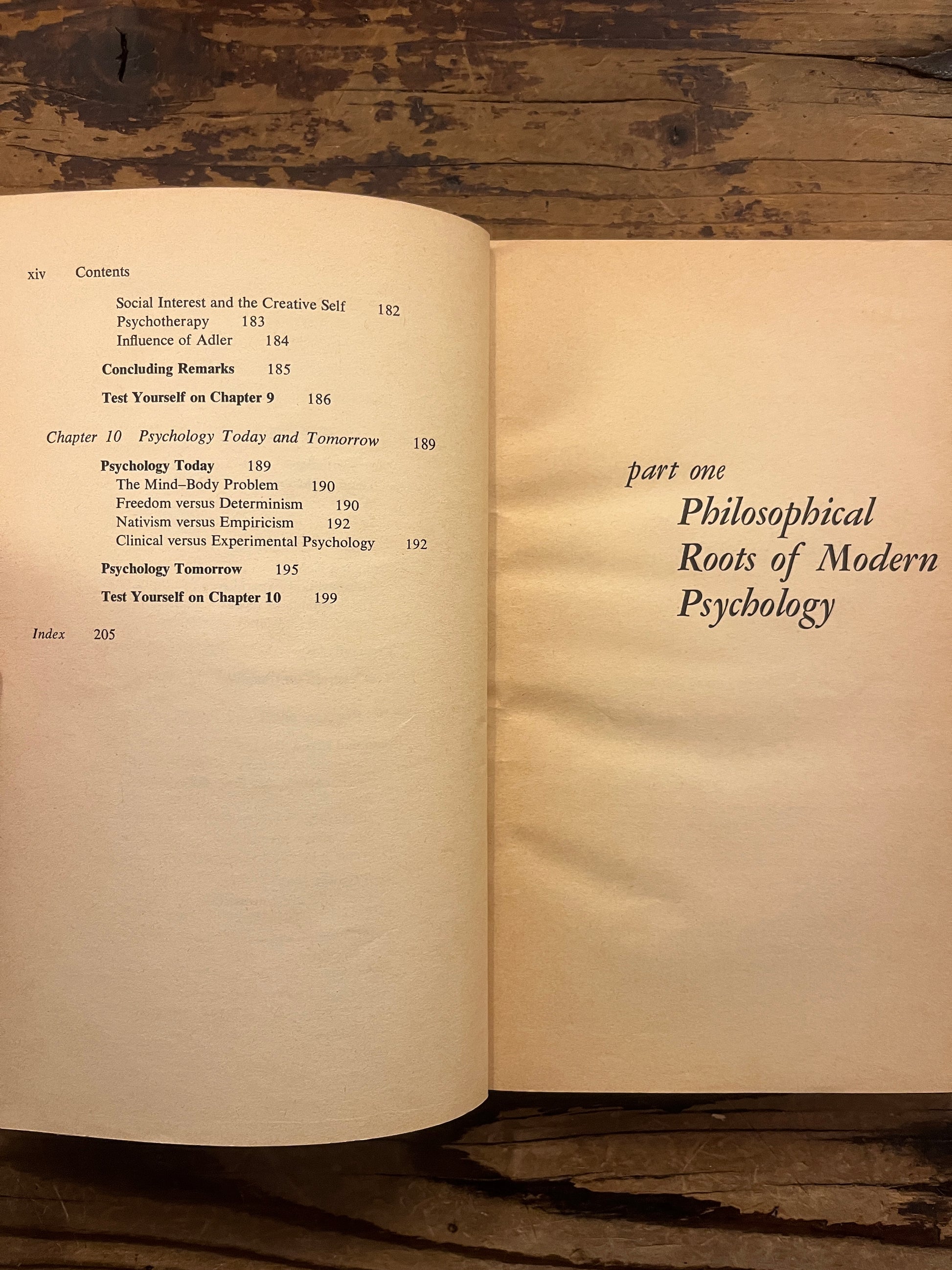 Open book titled 'the story of psychology'  by Frank J. Bruno on a wooden surface 