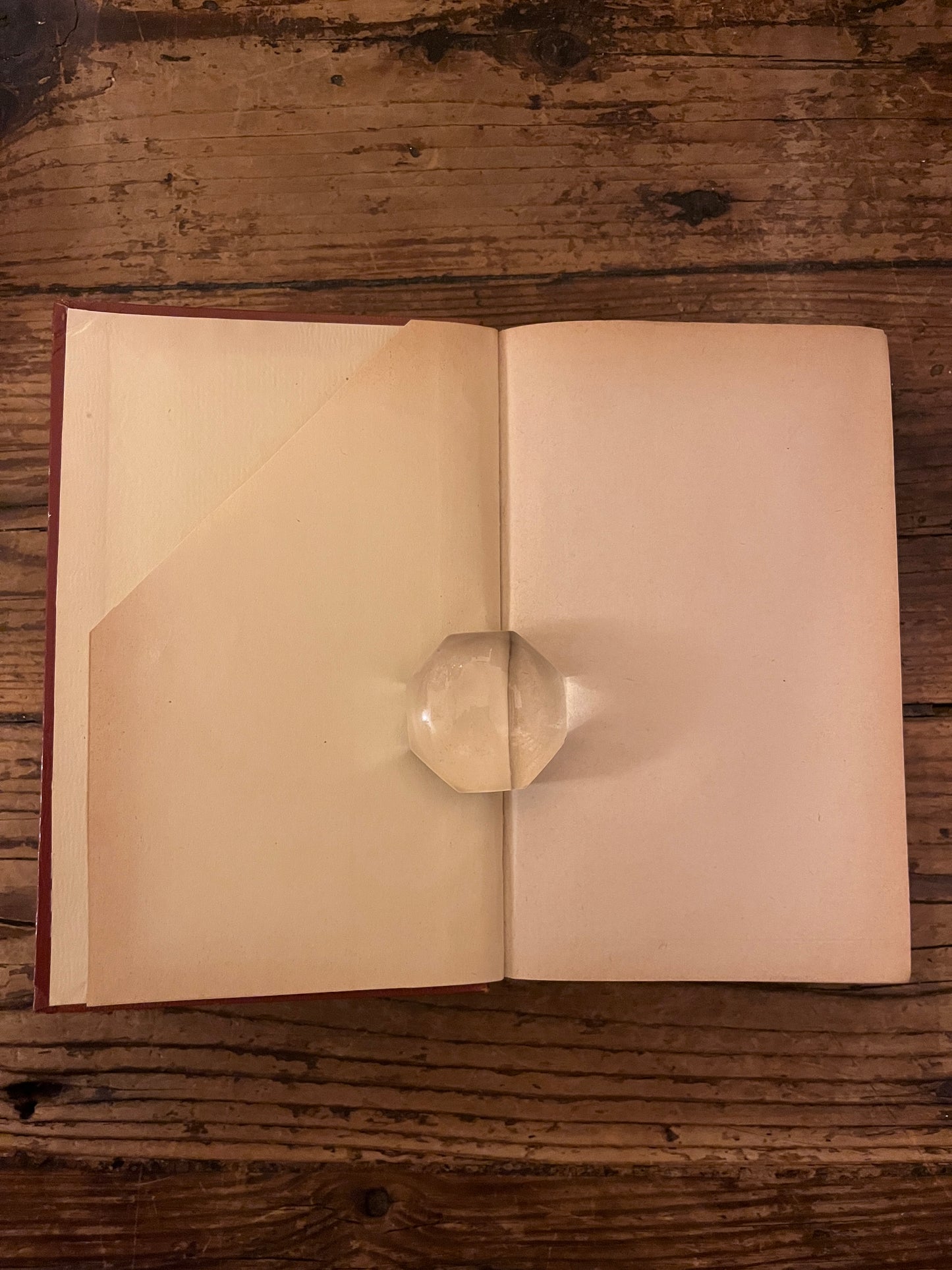 photo de la première page du livre "pensees" sur fond de bois On y voit que celle ci est coupée en diagonale