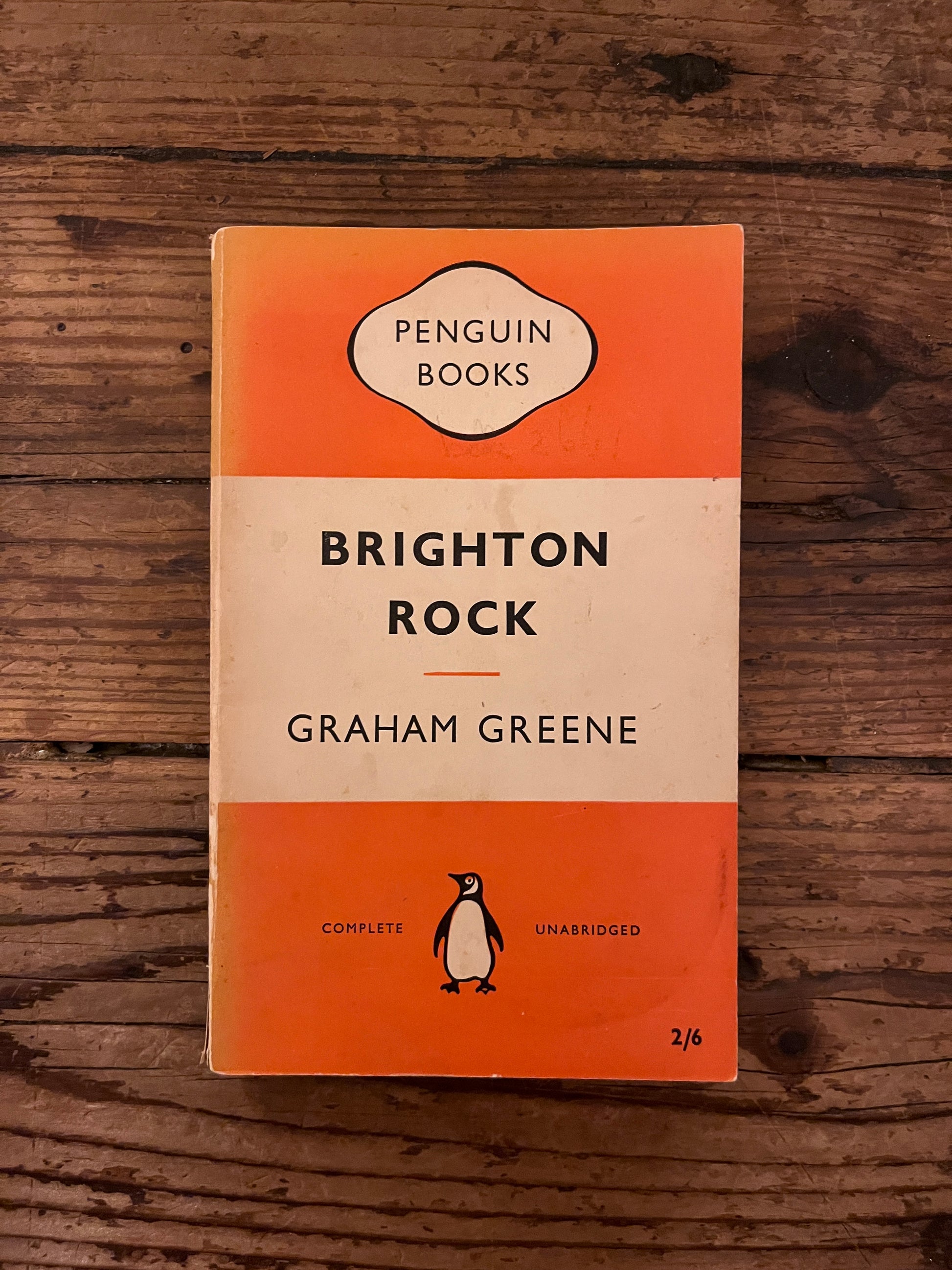 photo of the cover of the book "brighton rock"on a wooden background