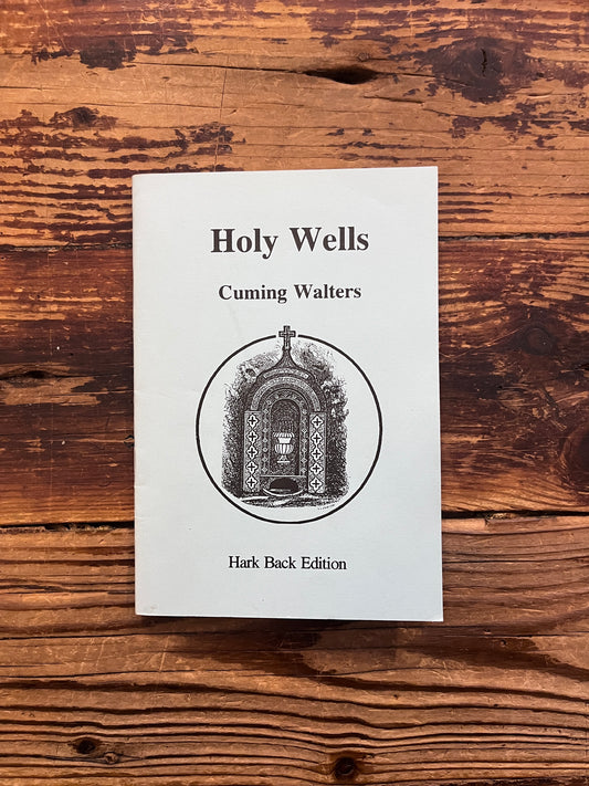 Front cover of booklet titled 'Holy Wells' by Cuming Walters on a wooden surface